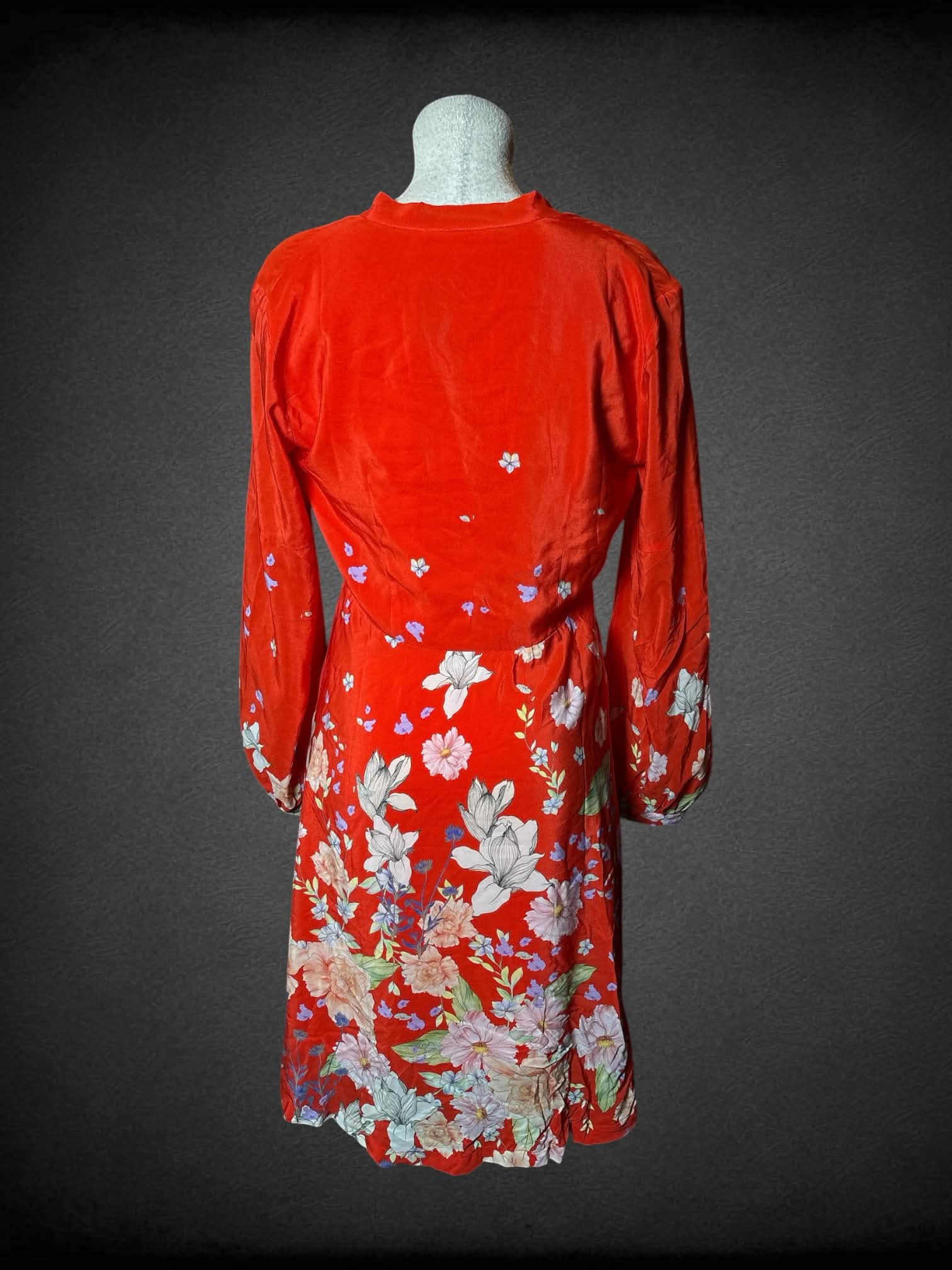 L Anthropologie red long-sleeve dress with tie around neck, floral design, and zipper on side