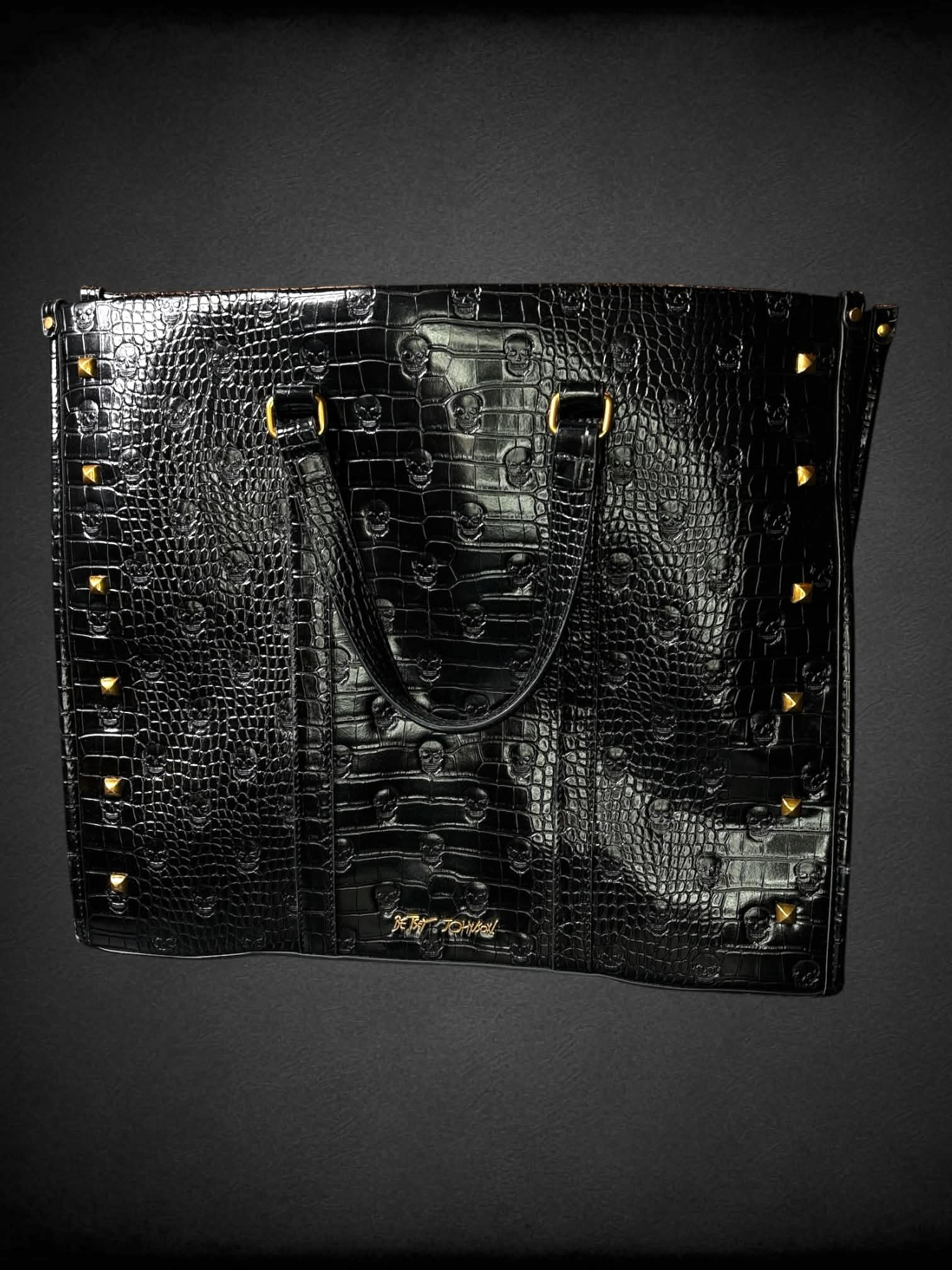 Betsey Johnson black skull Croc-embossed faux leather hand bag with zipper pockets, and gold studded detailing