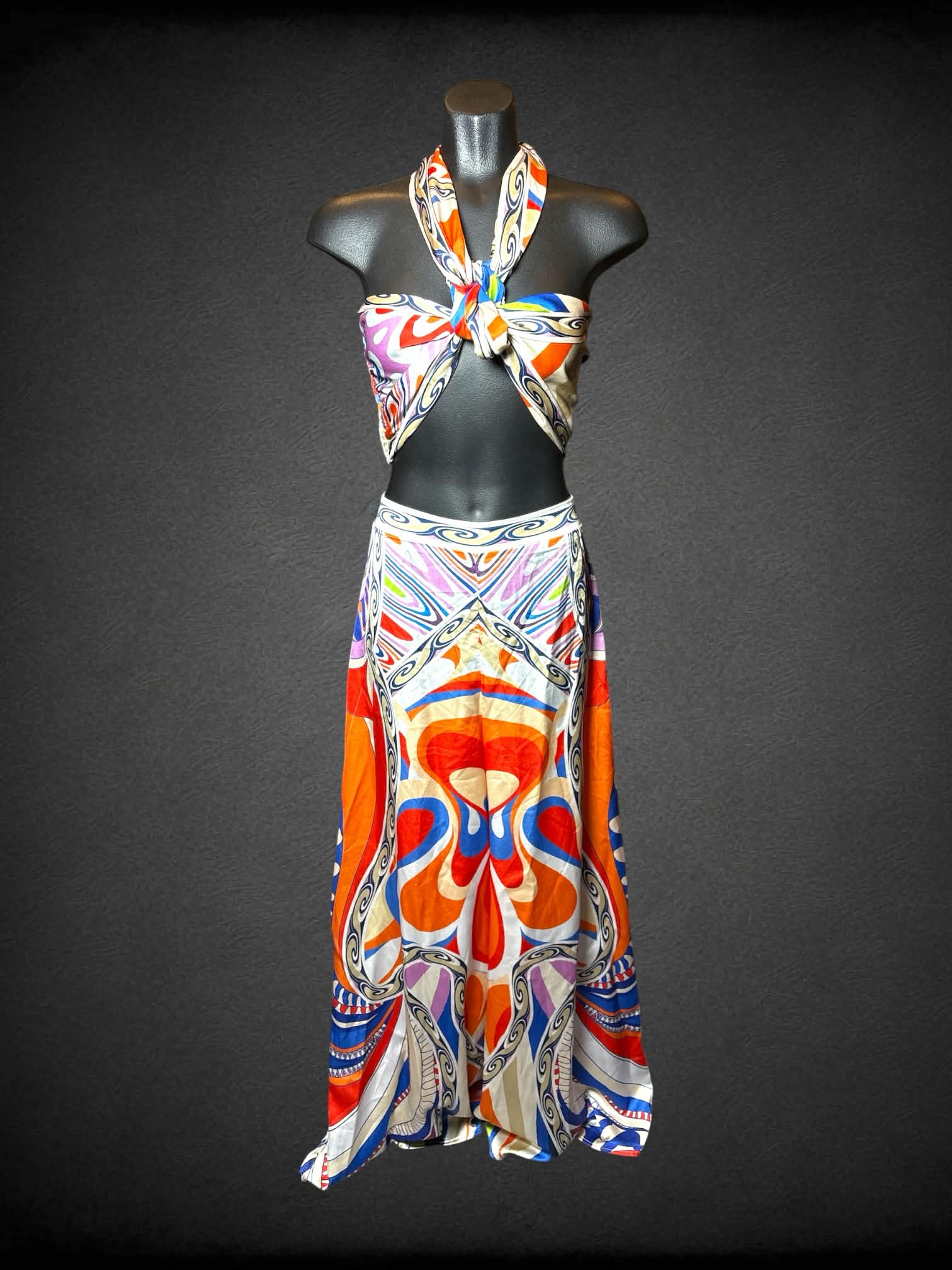 M Her…Bottari two piece set featuring white flowy pants with colorful symmetrical pattern, and wrap-up top with shirred back