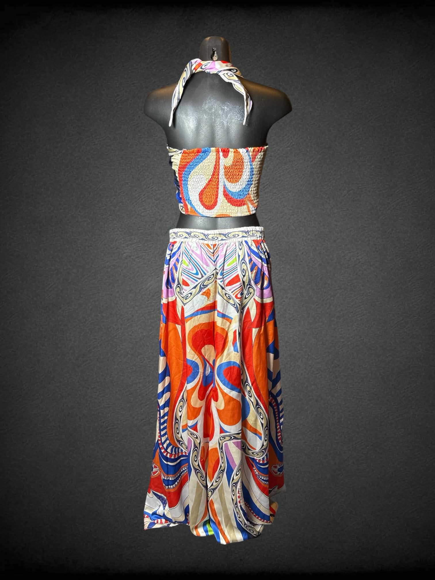 M Her…Bottari two piece set featuring white flowy pants with colorful symmetrical pattern, and wrap-up top with shirred back