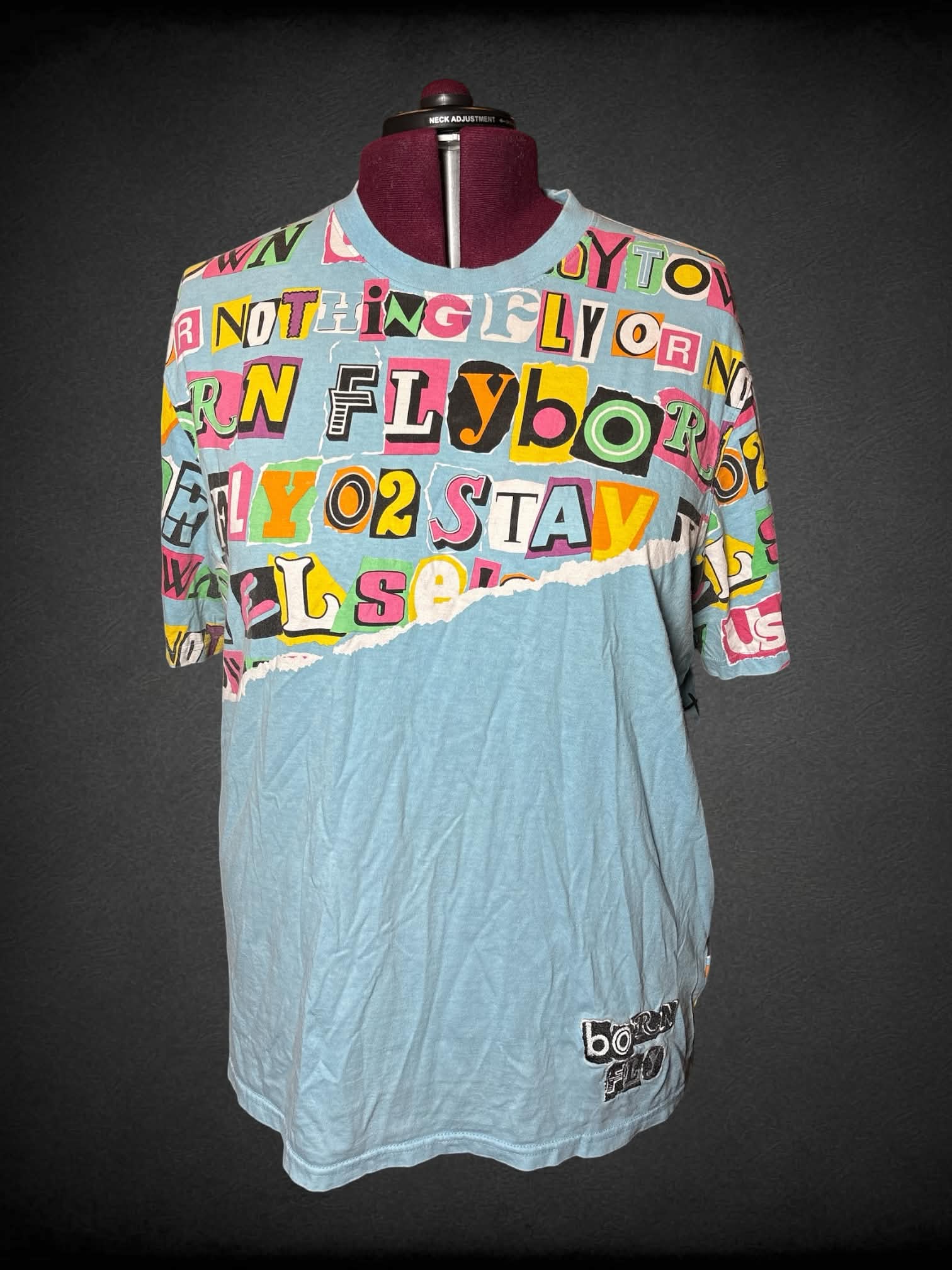 3X Born Fly light blue t shirt with wording graphic on front and back, and embroidered “Born Fly” on front