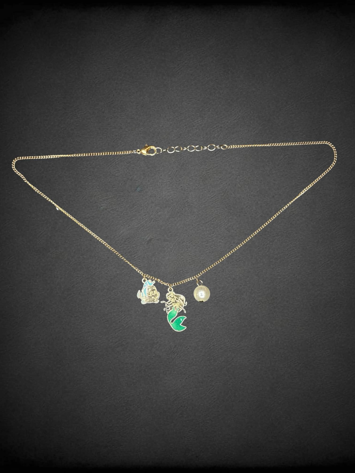 Gold chain necklace with Disney’s “The Little Mermaid” charms