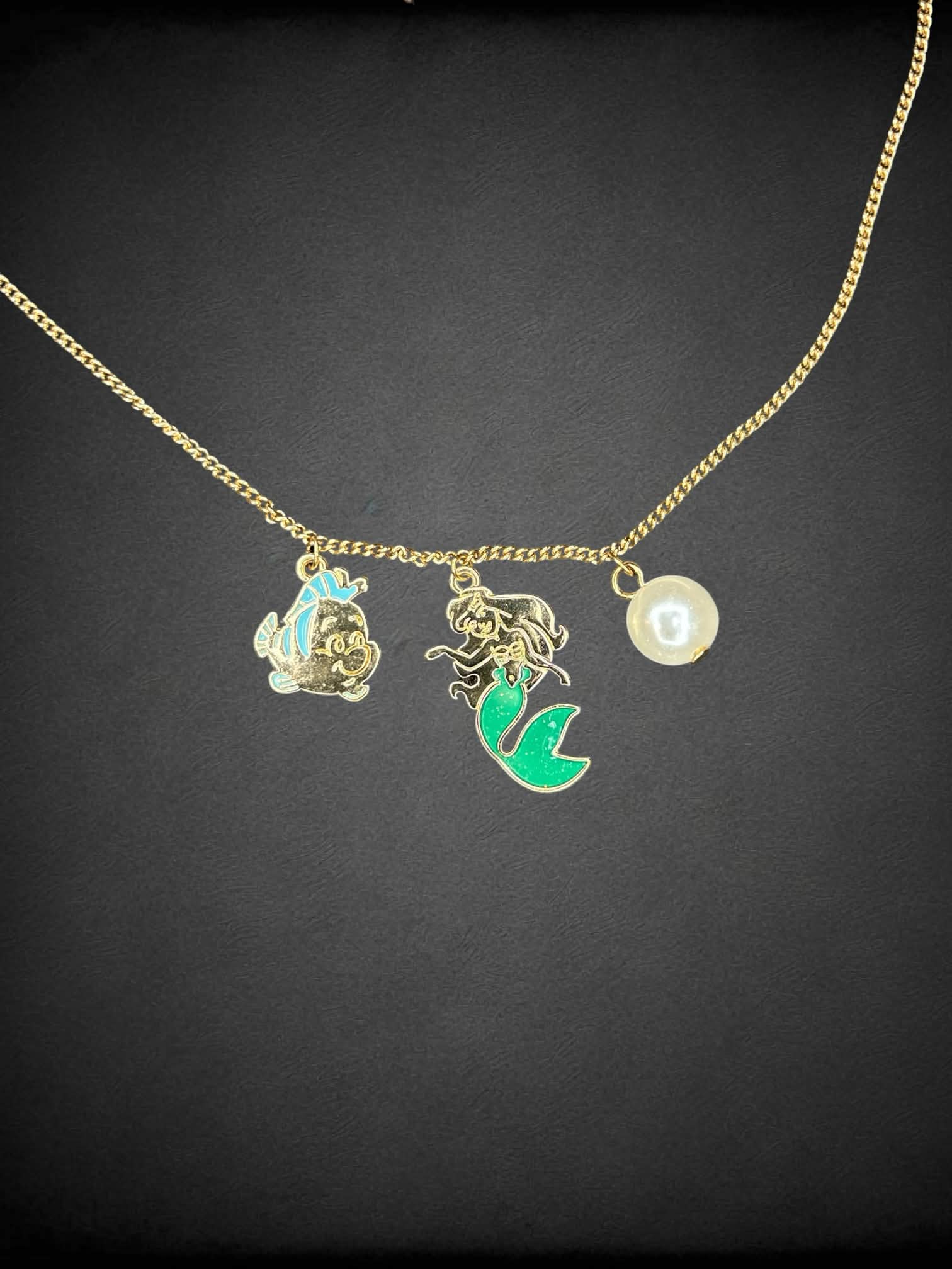 Gold chain necklace with Disney’s “The Little Mermaid” charms