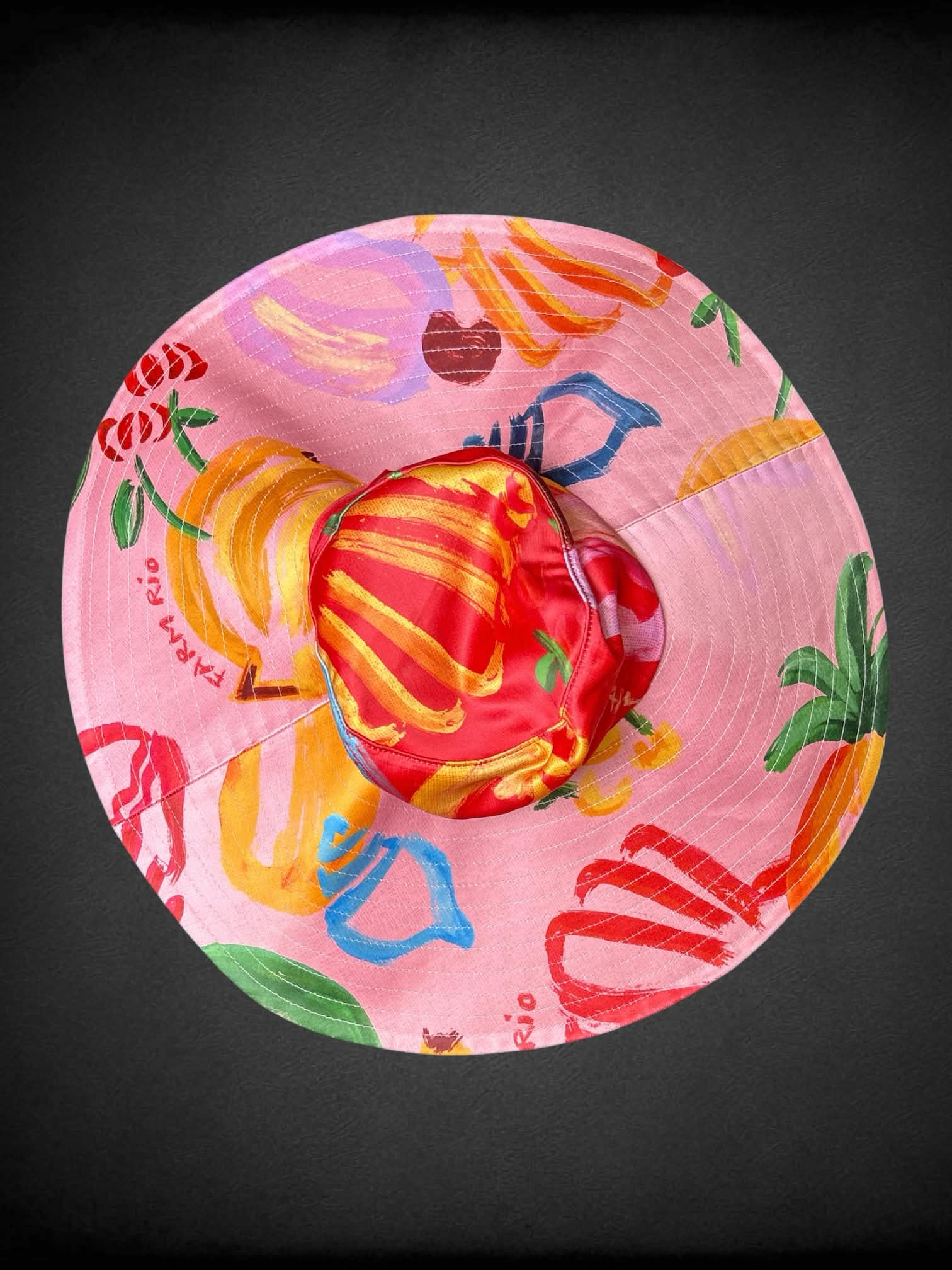 Farm Rio pink wide-brimmed sunhat with tropical fruit pattern, and under chin tie