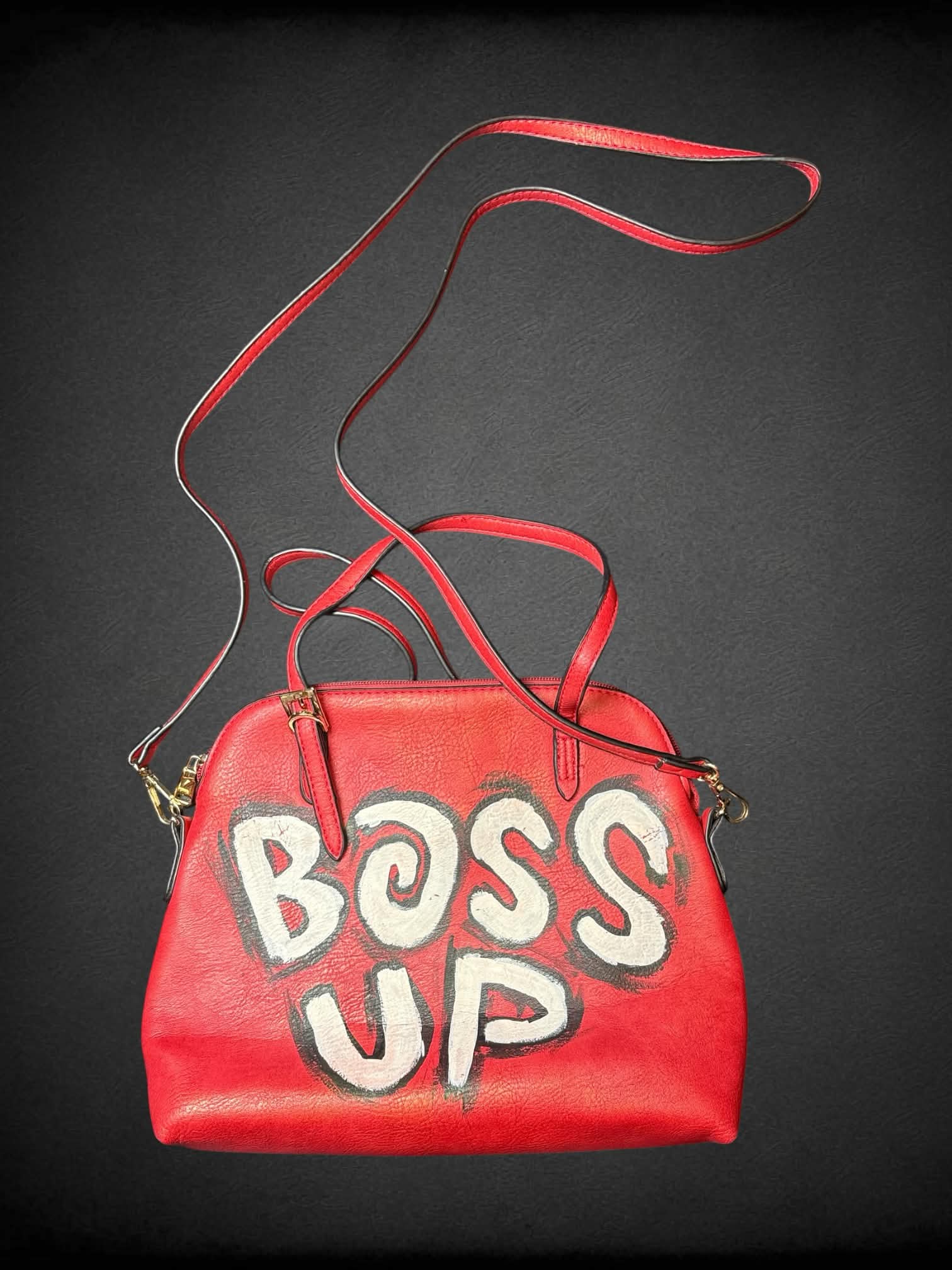Red faux leather shoulder bag with hand-painted “Boss Up” writing on front