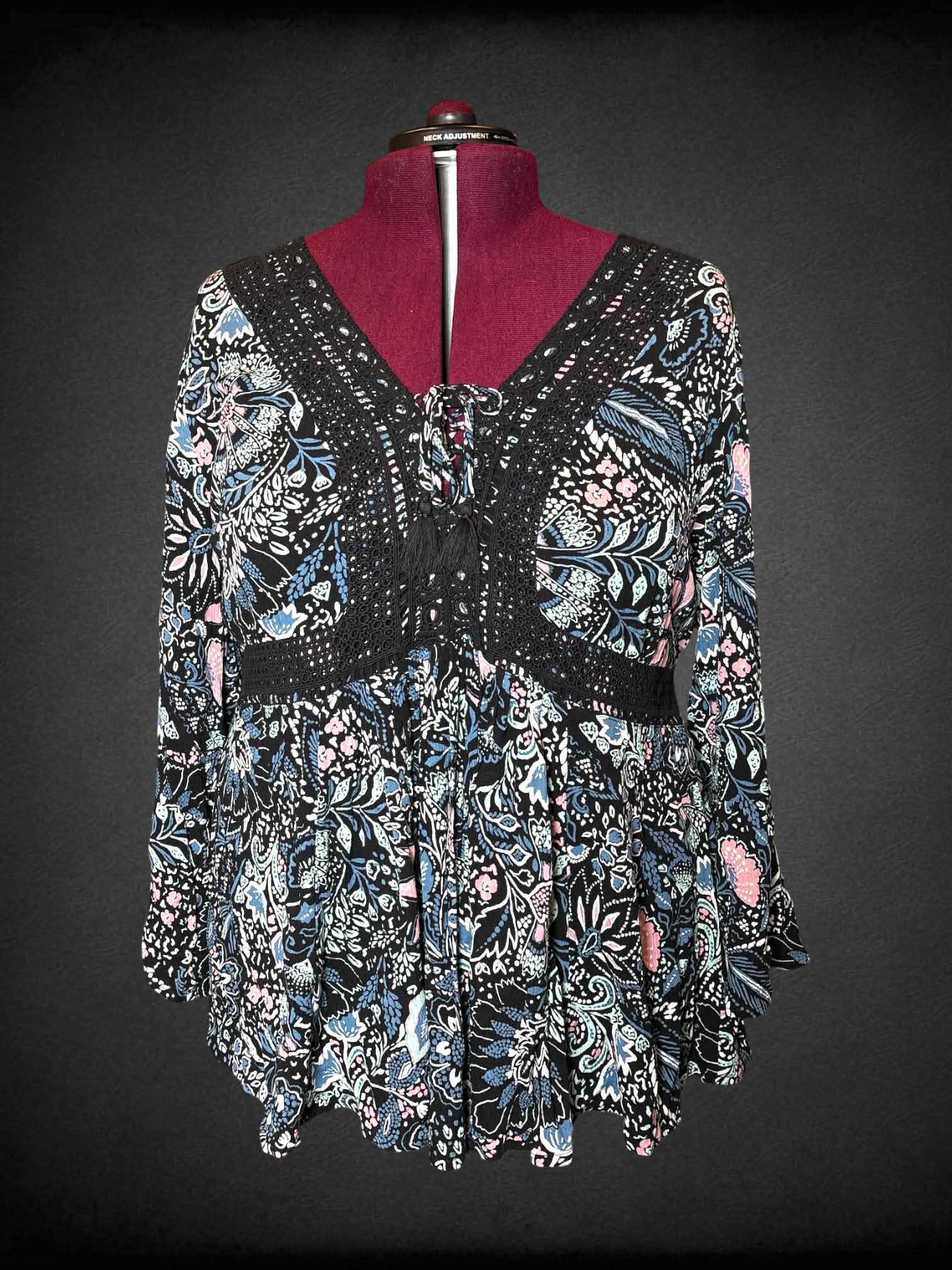 2X Torrid black blouse with colorful floral pattern, black embroidery trimming, and empire waist seem