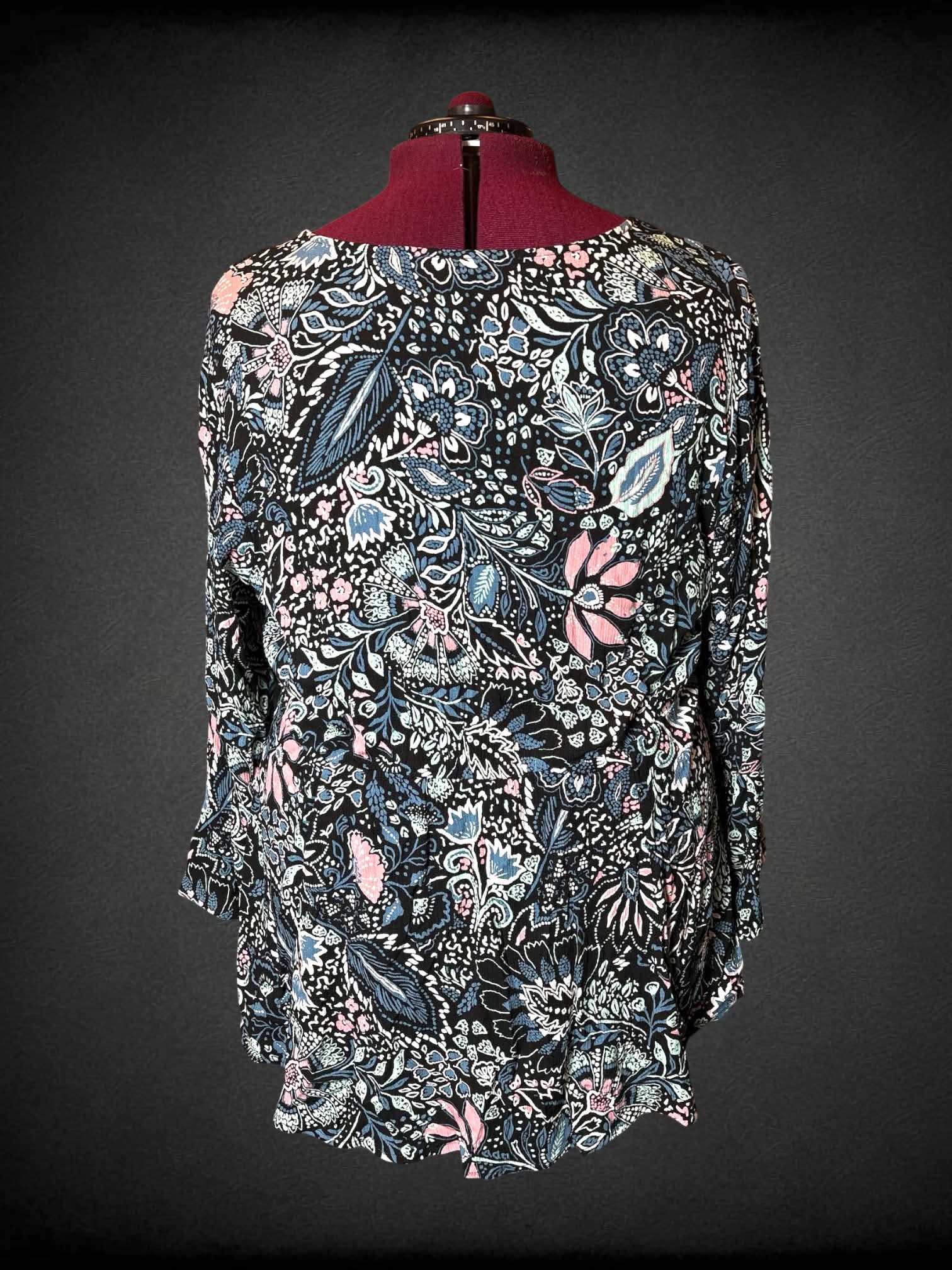 2X Torrid black blouse with colorful floral pattern, black embroidery trimming, and empire waist seem