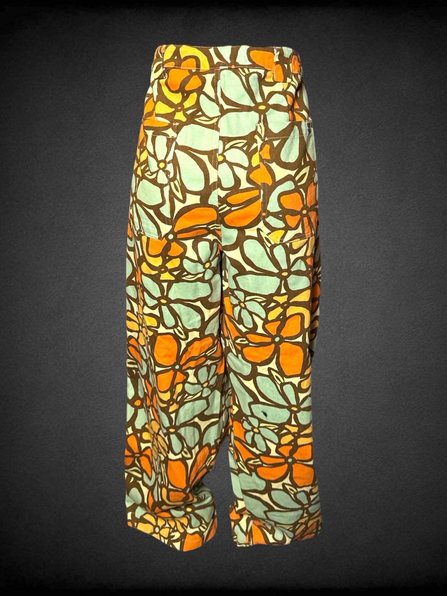 L Lucy & Yak yellow high-waisted pants with 70’s style orange & green floral pattern