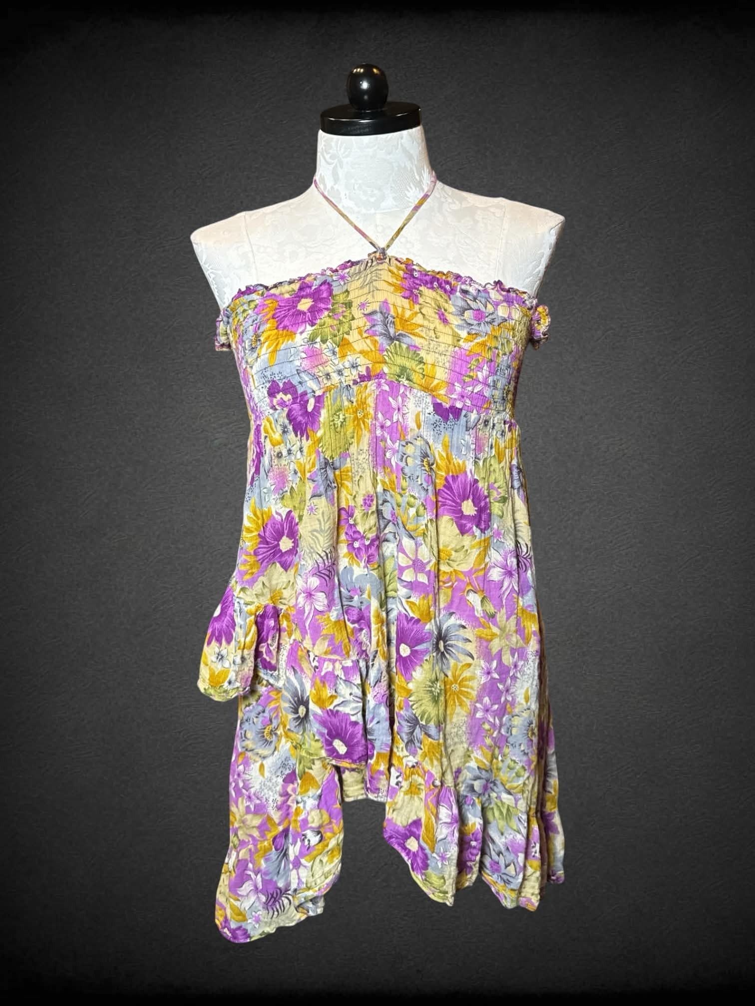 1X purple flowy halter top, with floral pattern, asymmetrical ruffle design, and empire waist seem