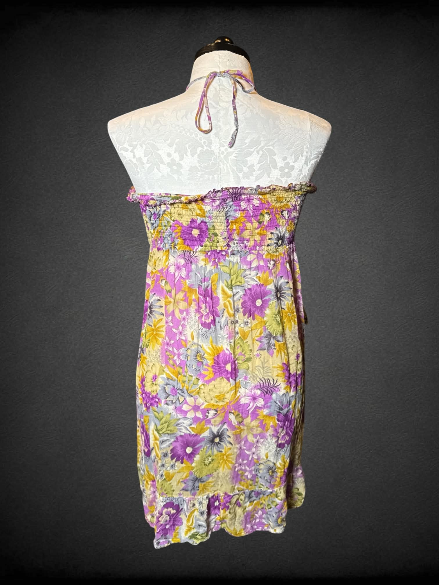 1X purple flowy halter top, with floral pattern, asymmetrical ruffle design, and empire waist seem