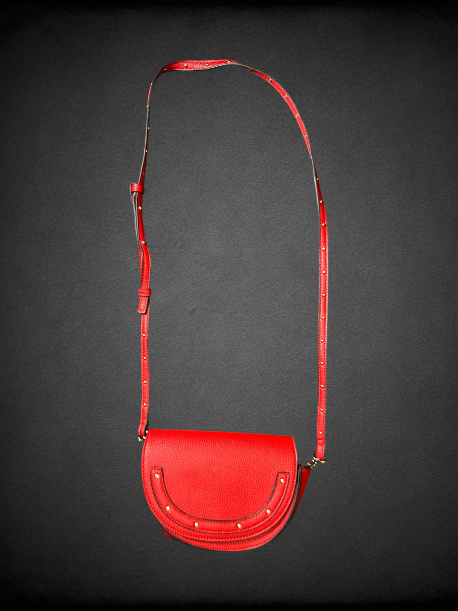 Steve Madden red textured faux leather shoulder bag with studded strap, and snap button pocket