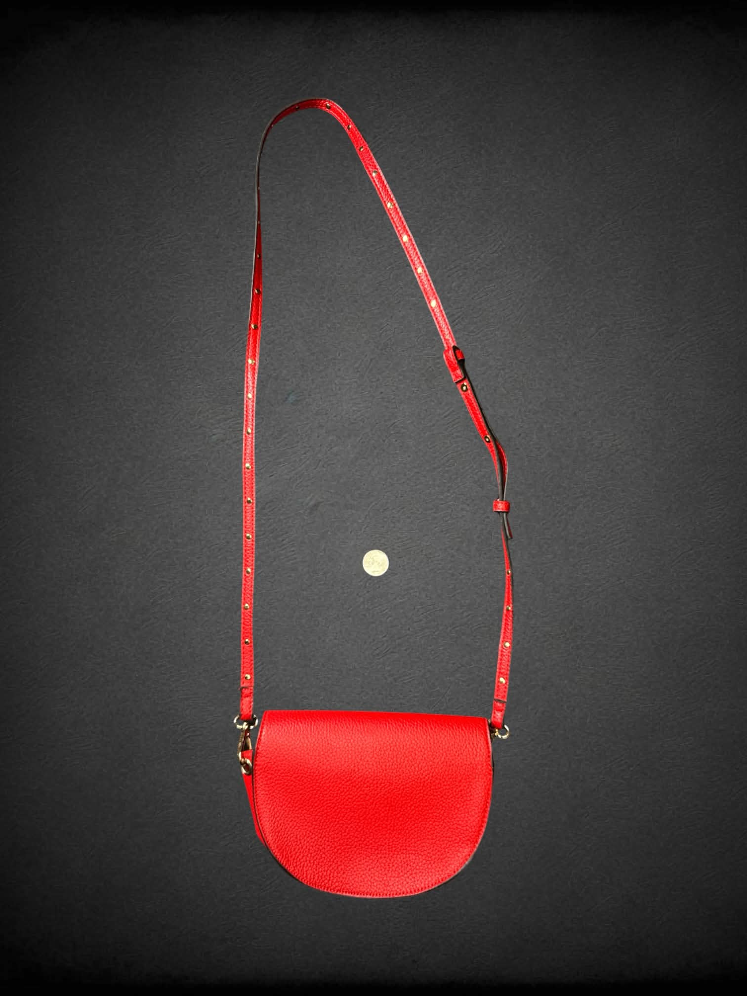 Steve Madden red textured faux leather shoulder bag with studded strap, and snap button pocket
