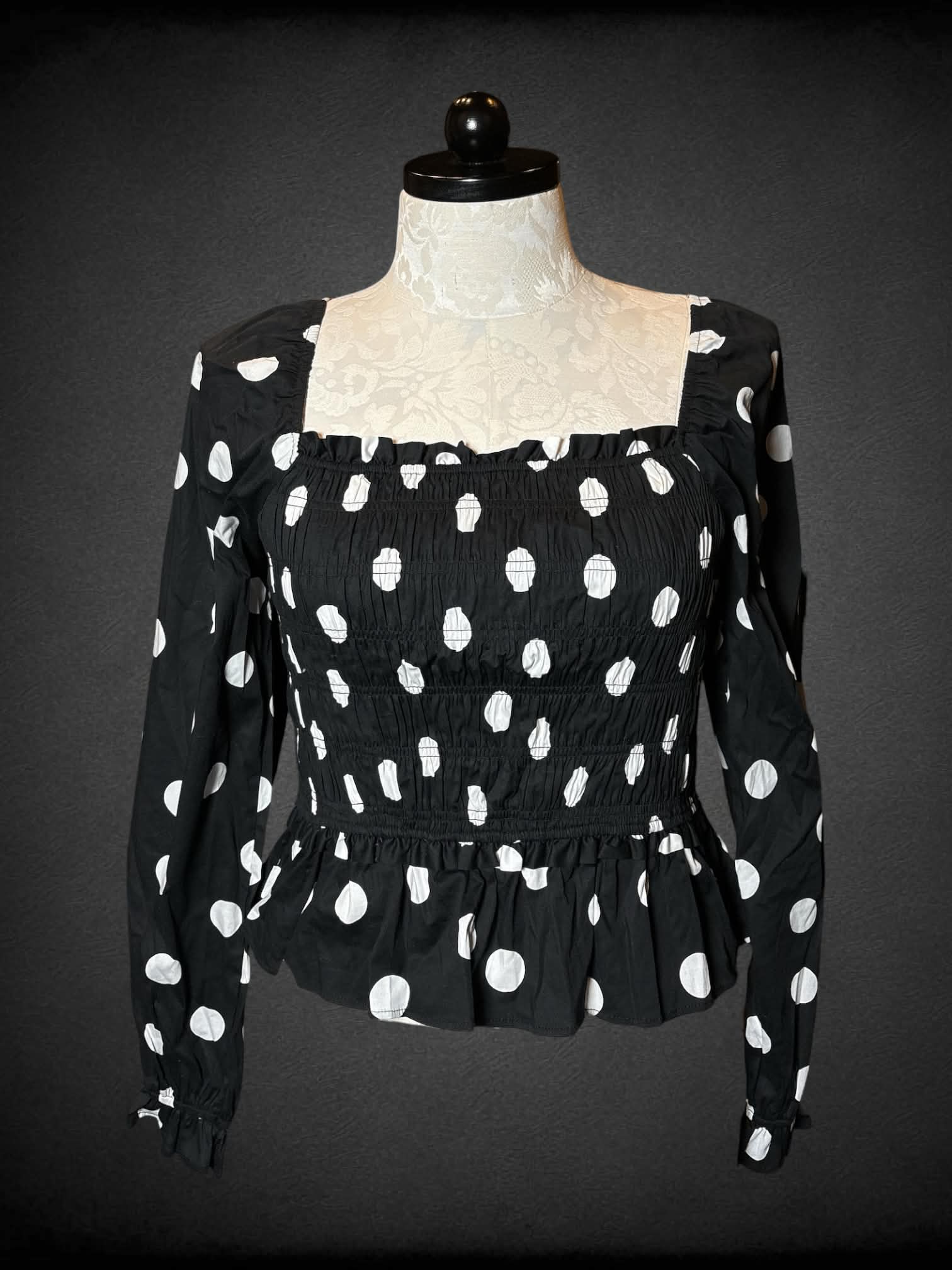 0X Francesca’s NWT black long-sleeve blouse with shirred top, white polka dot pattern, and decorative bows on back