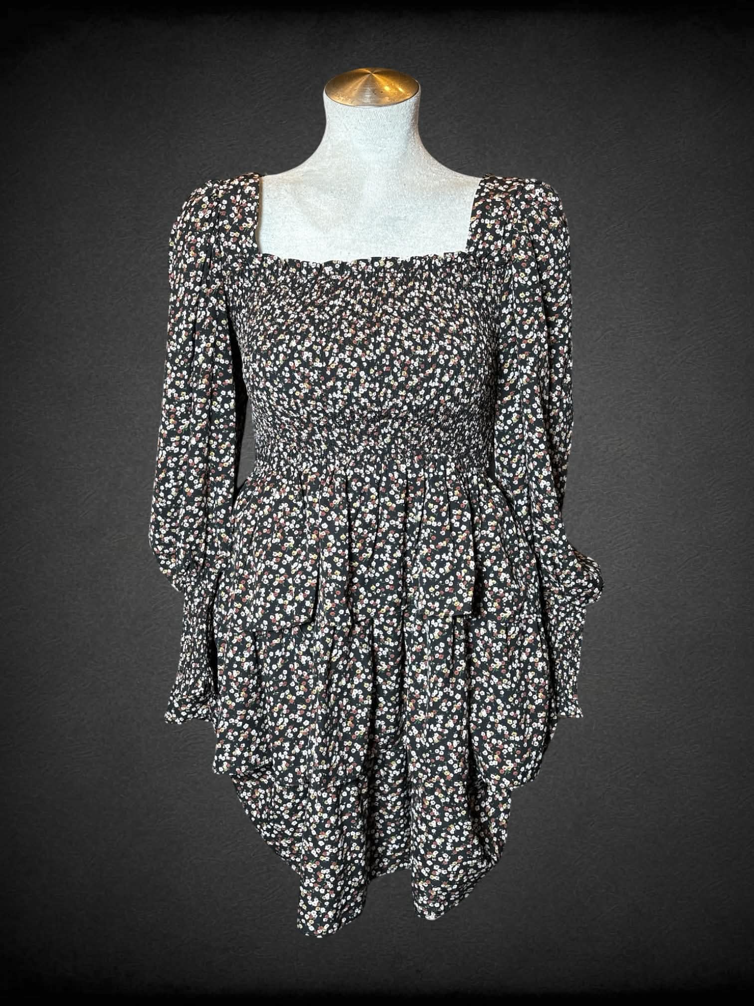 L Byinns black long-sleeve short dress with floral pattern, shirred top, ruffled design on skirt, and cutout on back