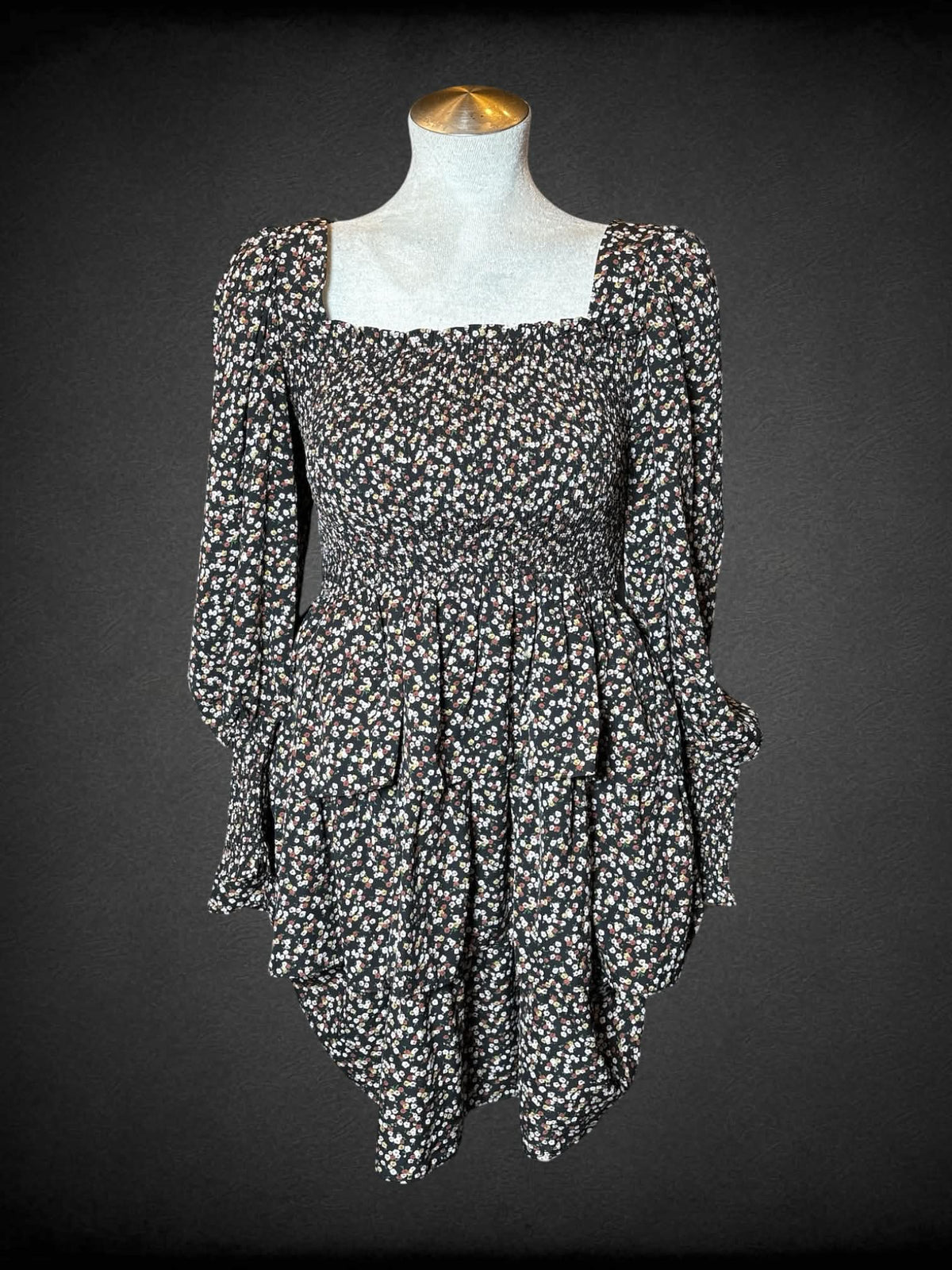 L Byinns black long-sleeve short dress with floral pattern, shirred top, ruffled design on skirt, and cutout on back