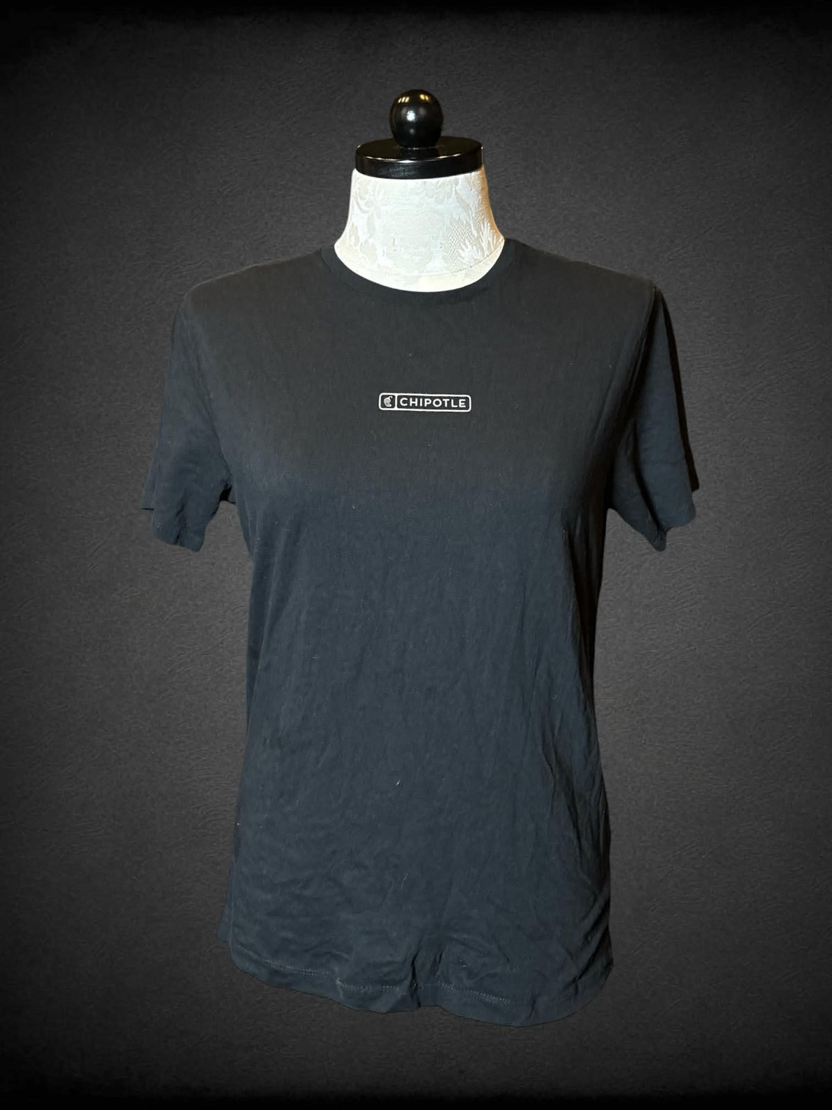1X Loomstate black t shirt with “Chipotle” logo on front and “As Real As It Gets” writing on back