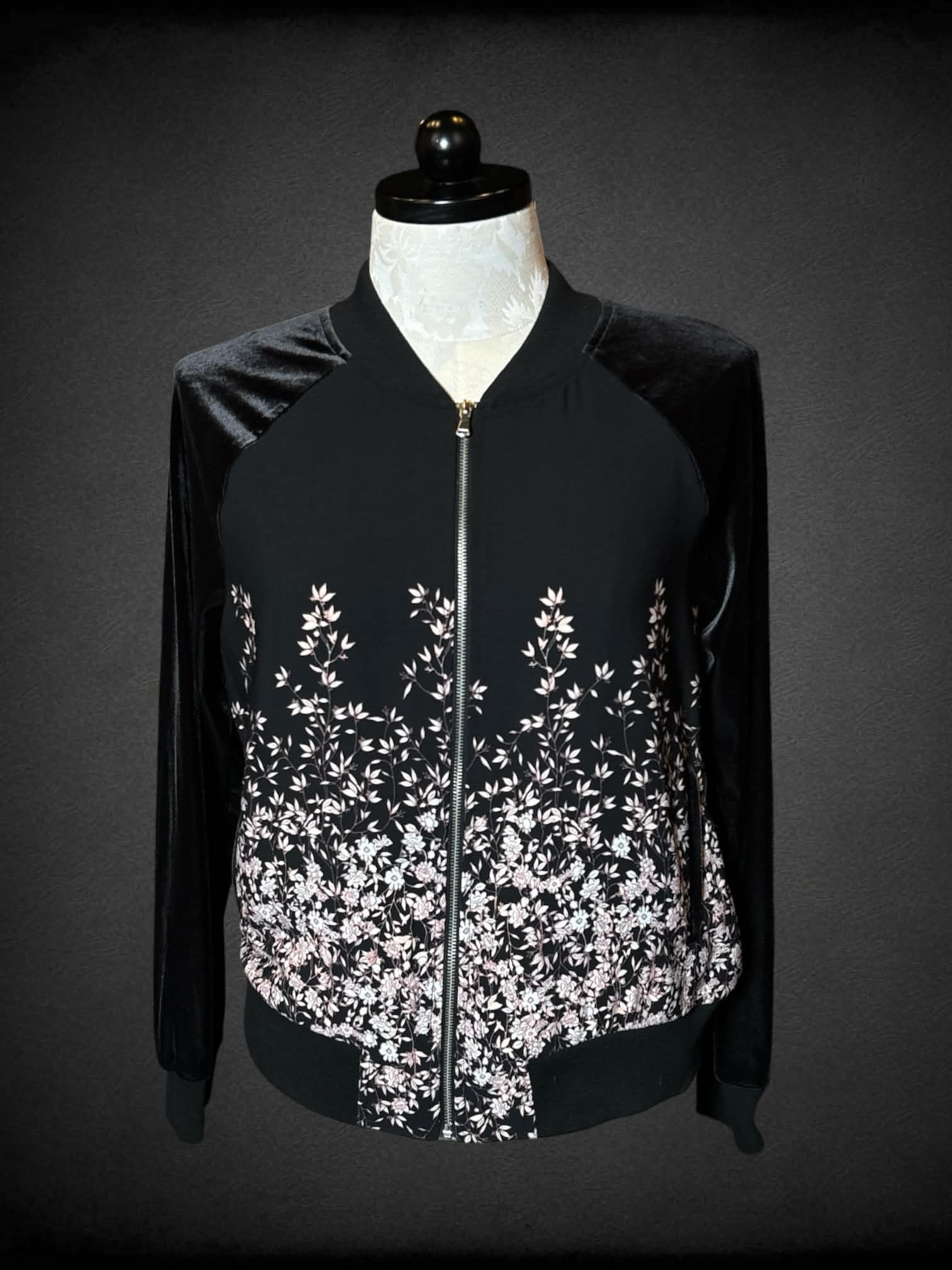 1X A New Day black bomber jacket with pink flower design, and “velvet-like” sleeves