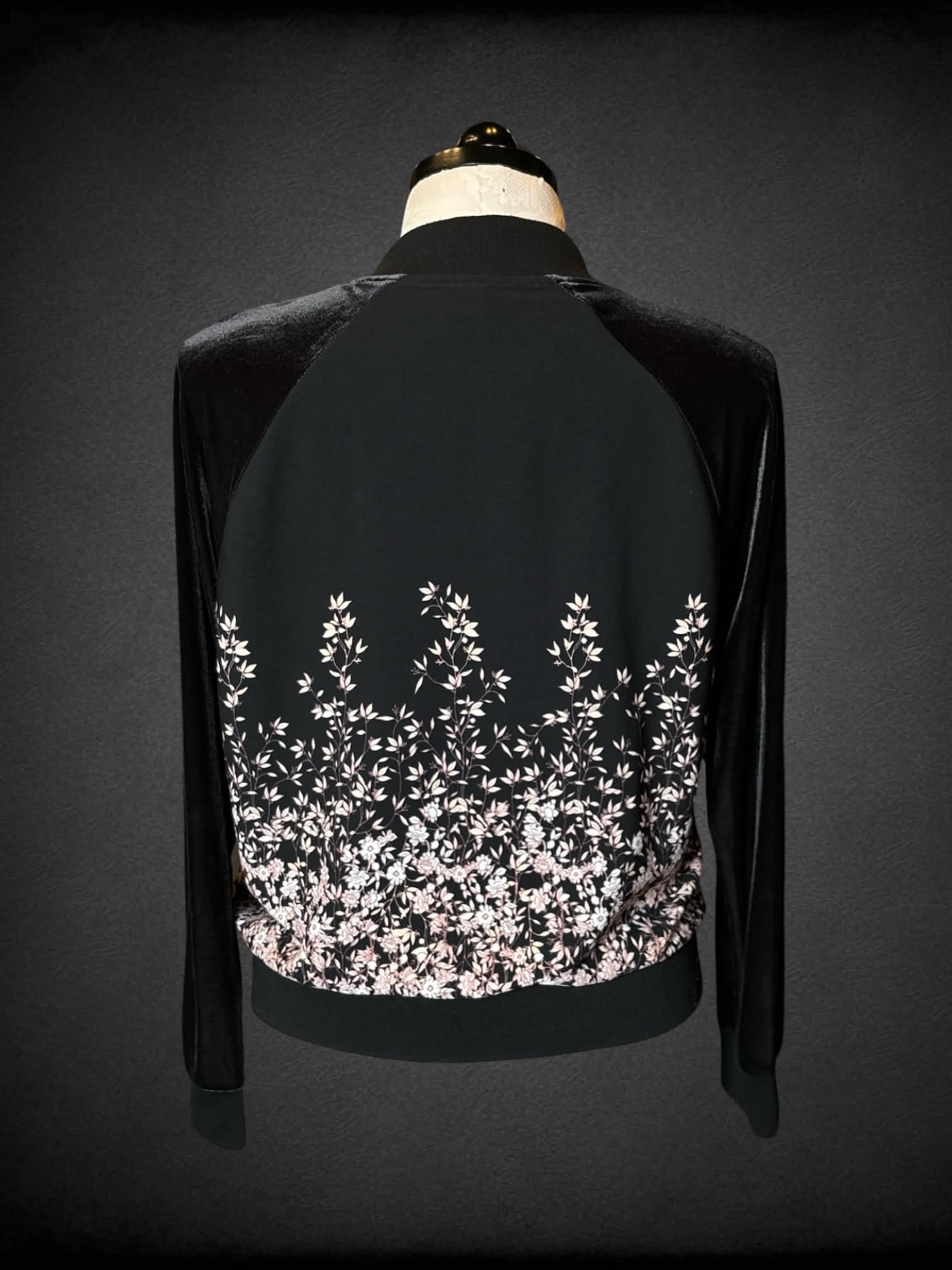 1X A New Day black bomber jacket with pink flower design, and “velvet-like” sleeves