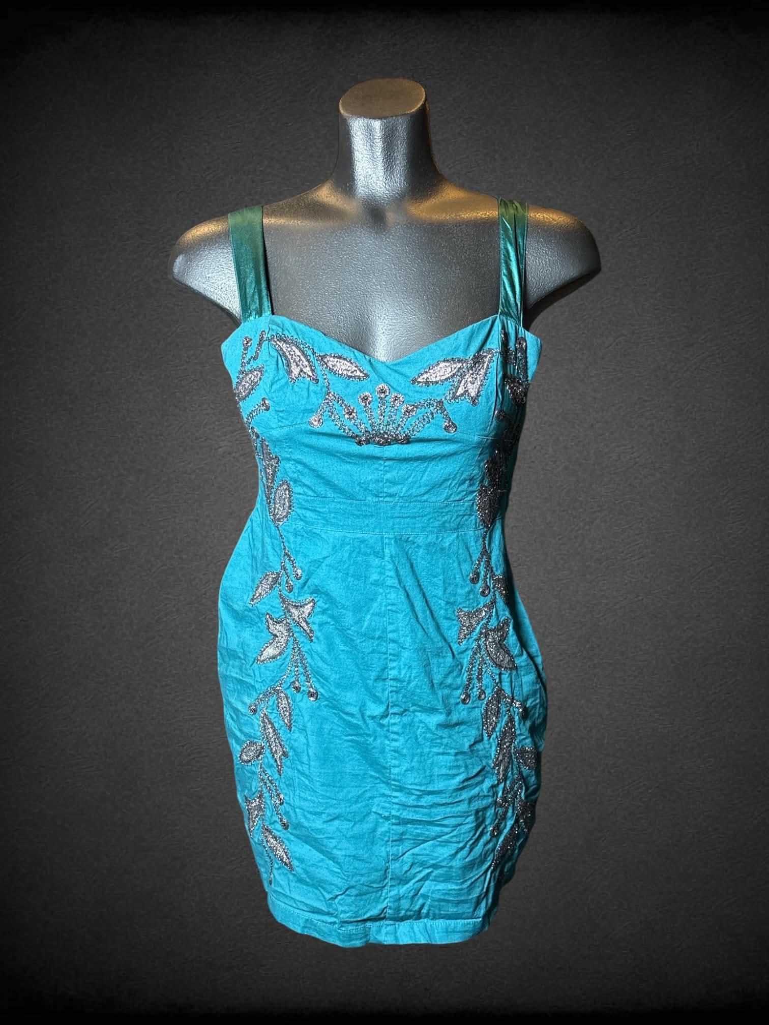M Free People teal short dress with silver embroidered floral design on front, and zipper on side