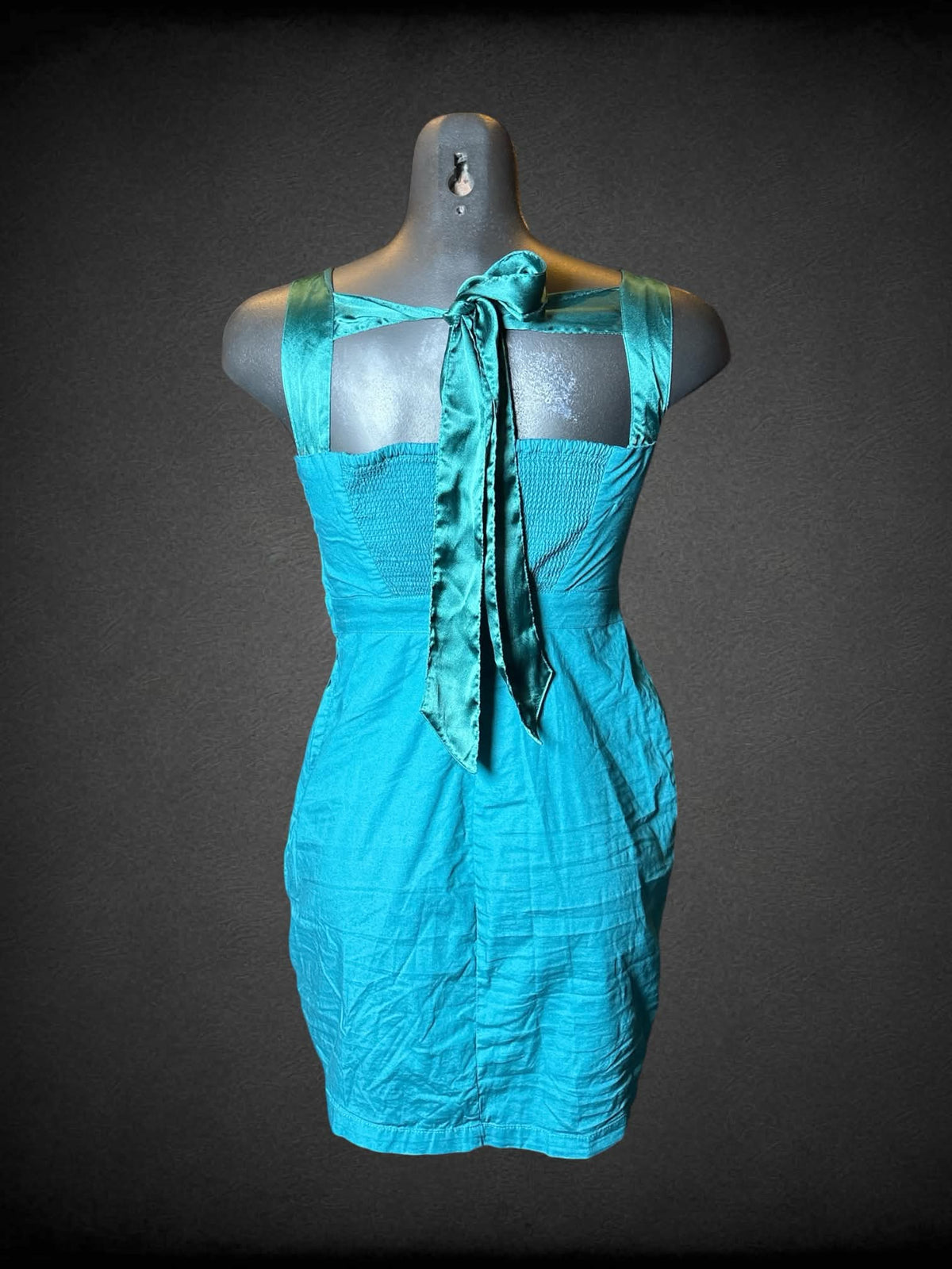 M Free People teal short dress with silver embroidered floral design on front, and zipper on side