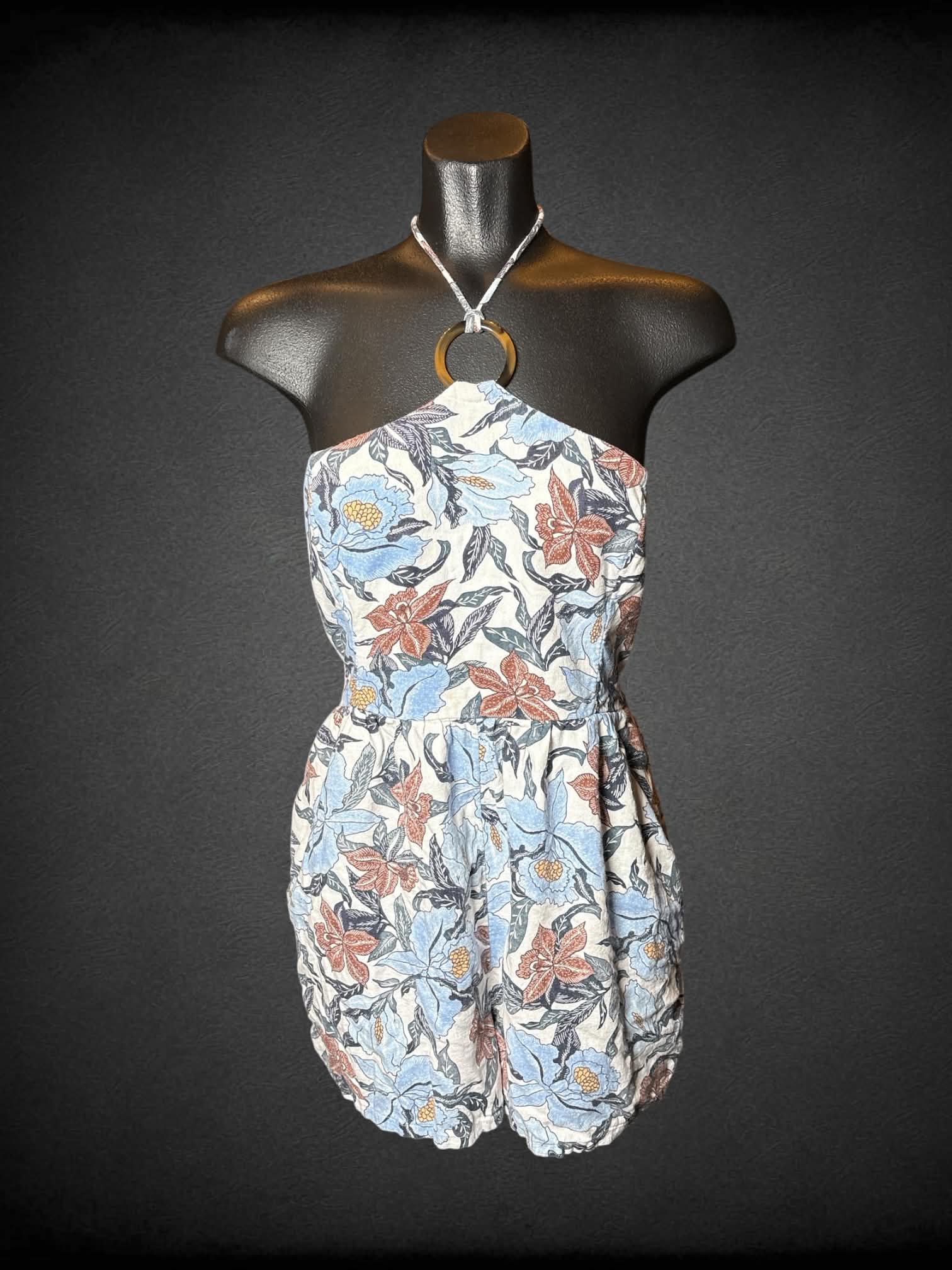 M Old Navy white halter jumpsuit with blue floral pattern, shirred back, and pockets