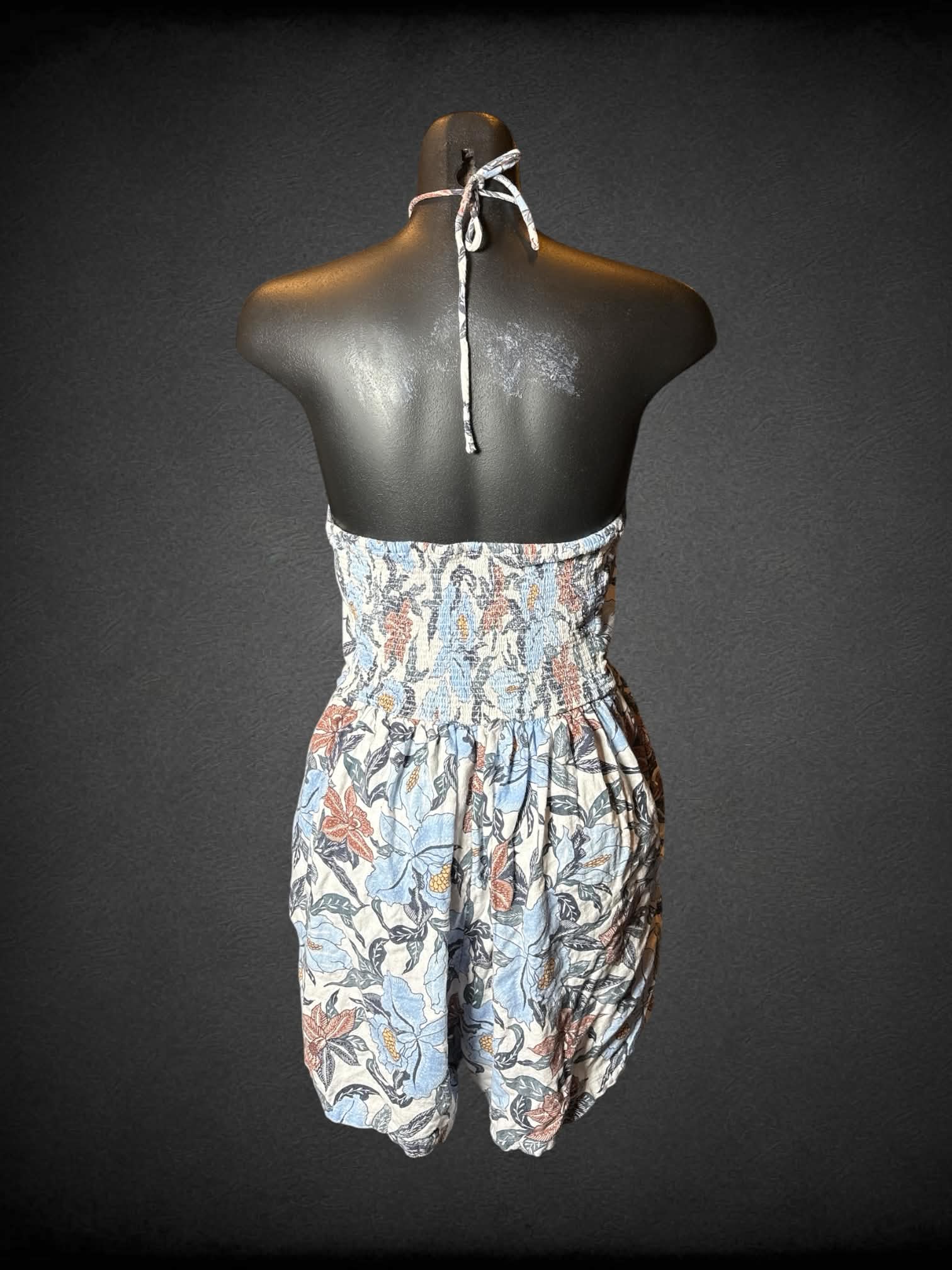 M Old Navy white halter jumpsuit with blue floral pattern, shirred back, and pockets