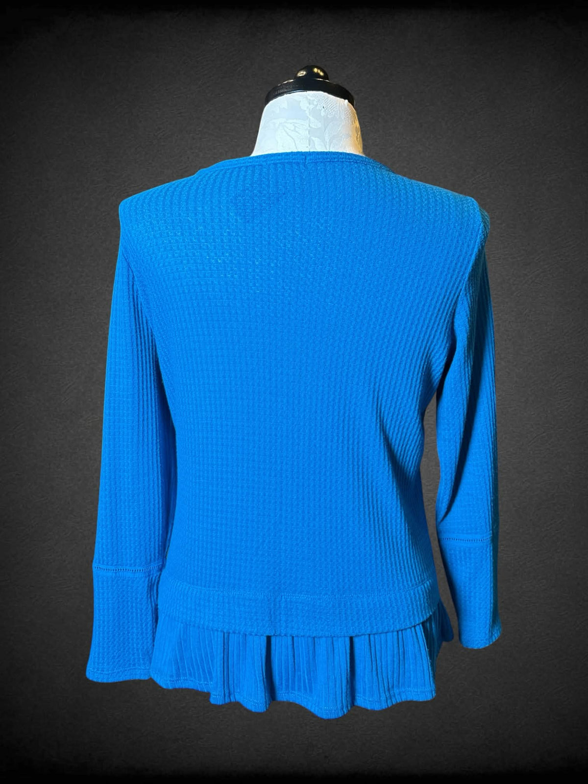 XL Isela blue knit long-sleeve sweater top with embroidered floral design on shoulders, and ruffle hem