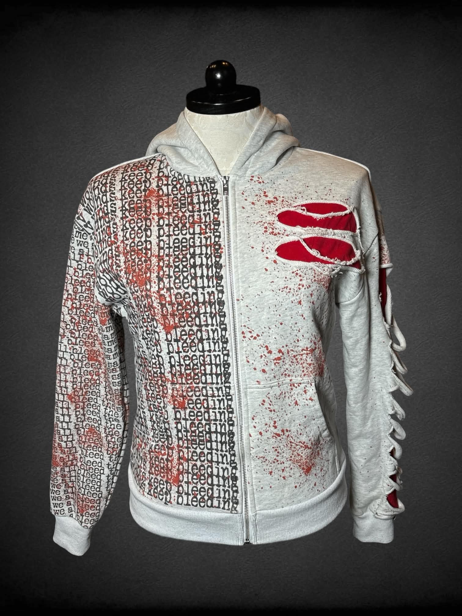 1X PS designer 1 of 200 grey distressed hoodie with fake blood stains, and “Keep Bleeding” design, and “We All Bleed” embroidery on hood