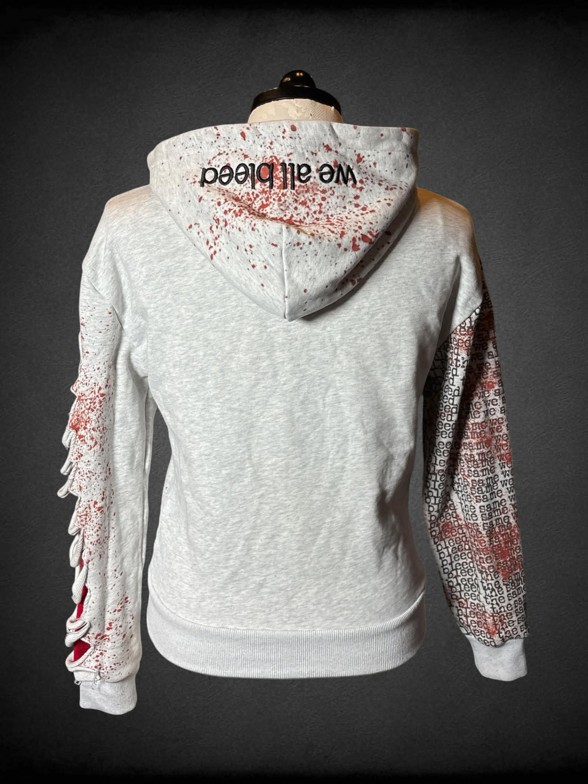 1X PS designer 1 of 200 grey distressed hoodie with fake blood stains, and “Keep Bleeding” design, and “We All Bleed” embroidery on hood