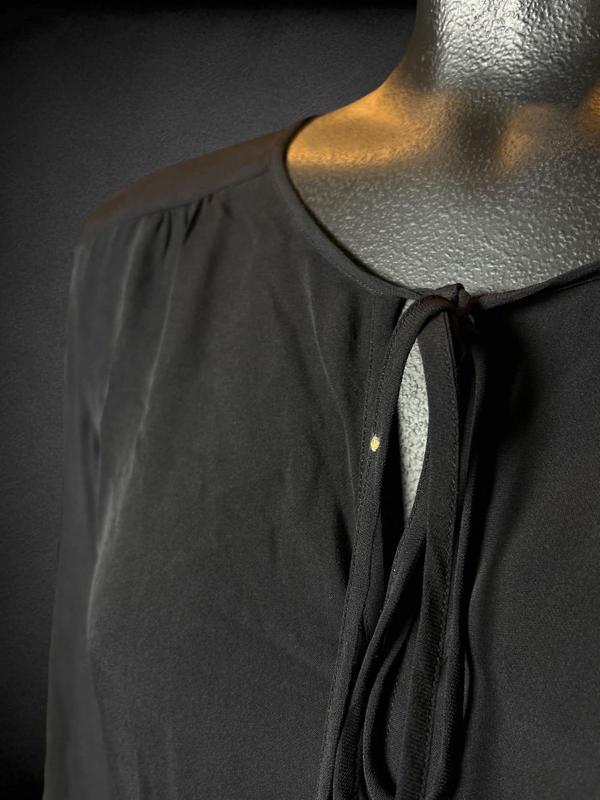 L Newport News black sheer silk long-sleeve blouse with tie up cutout design on fron
