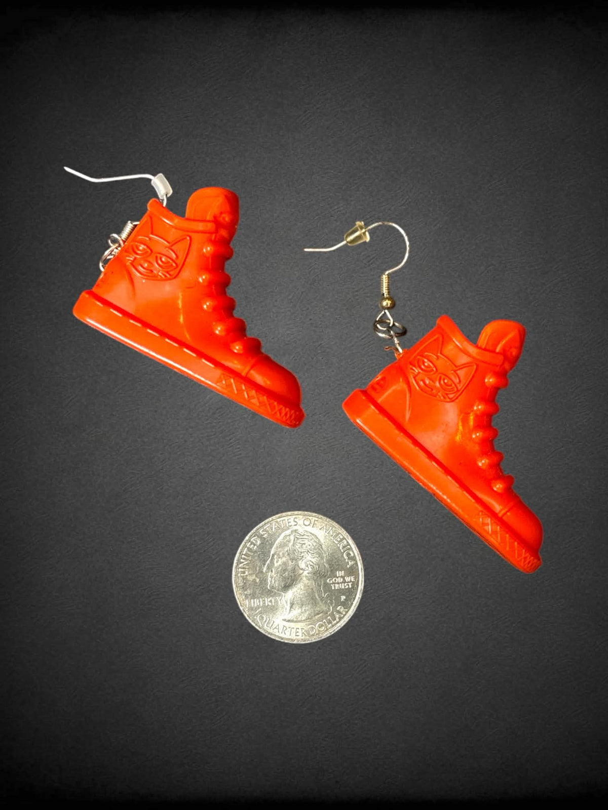 Orange plastic shoe earrings with “Pete The Cat” character