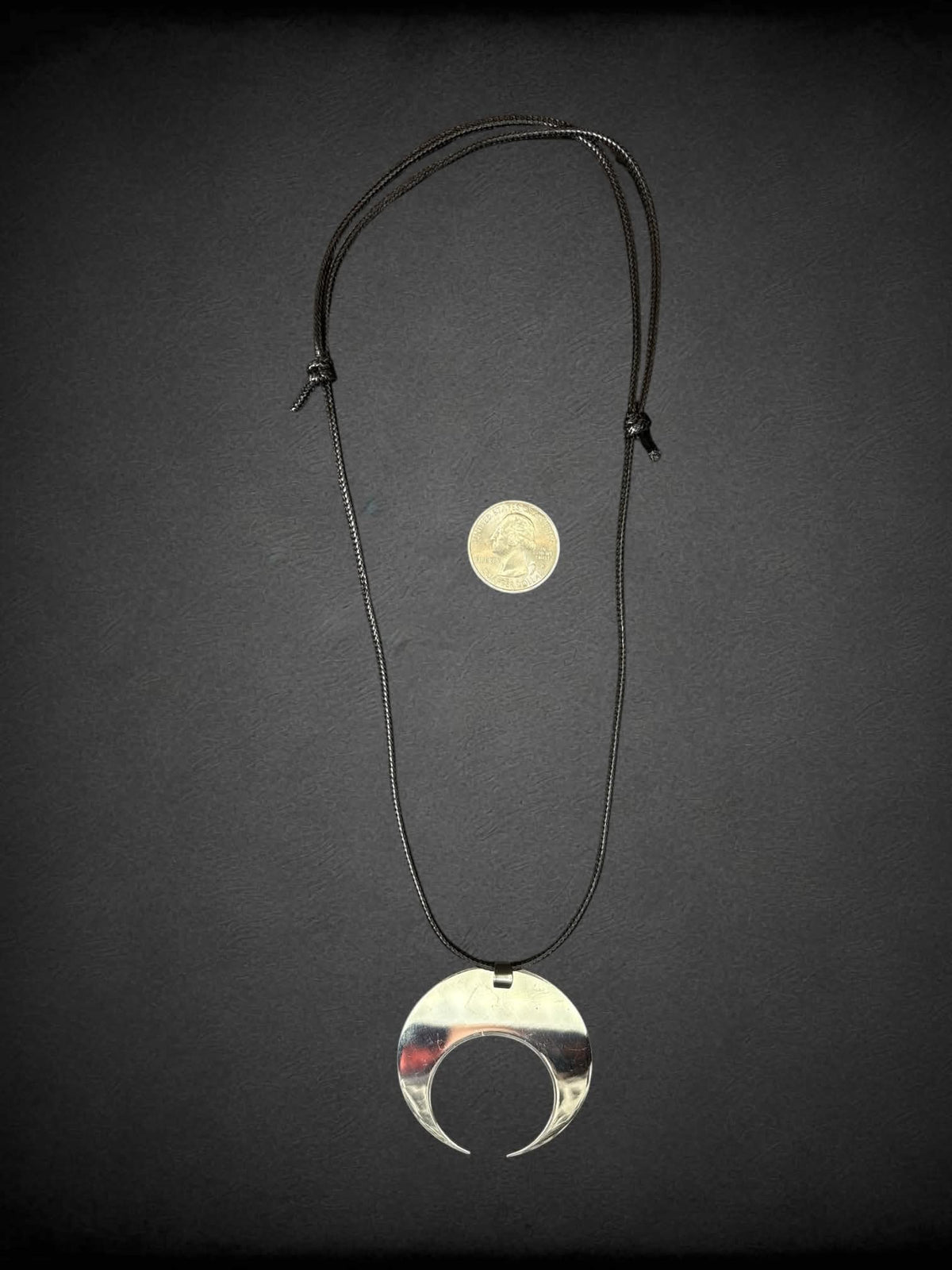Tunnel Vision black cord necklace with metallic moon charm