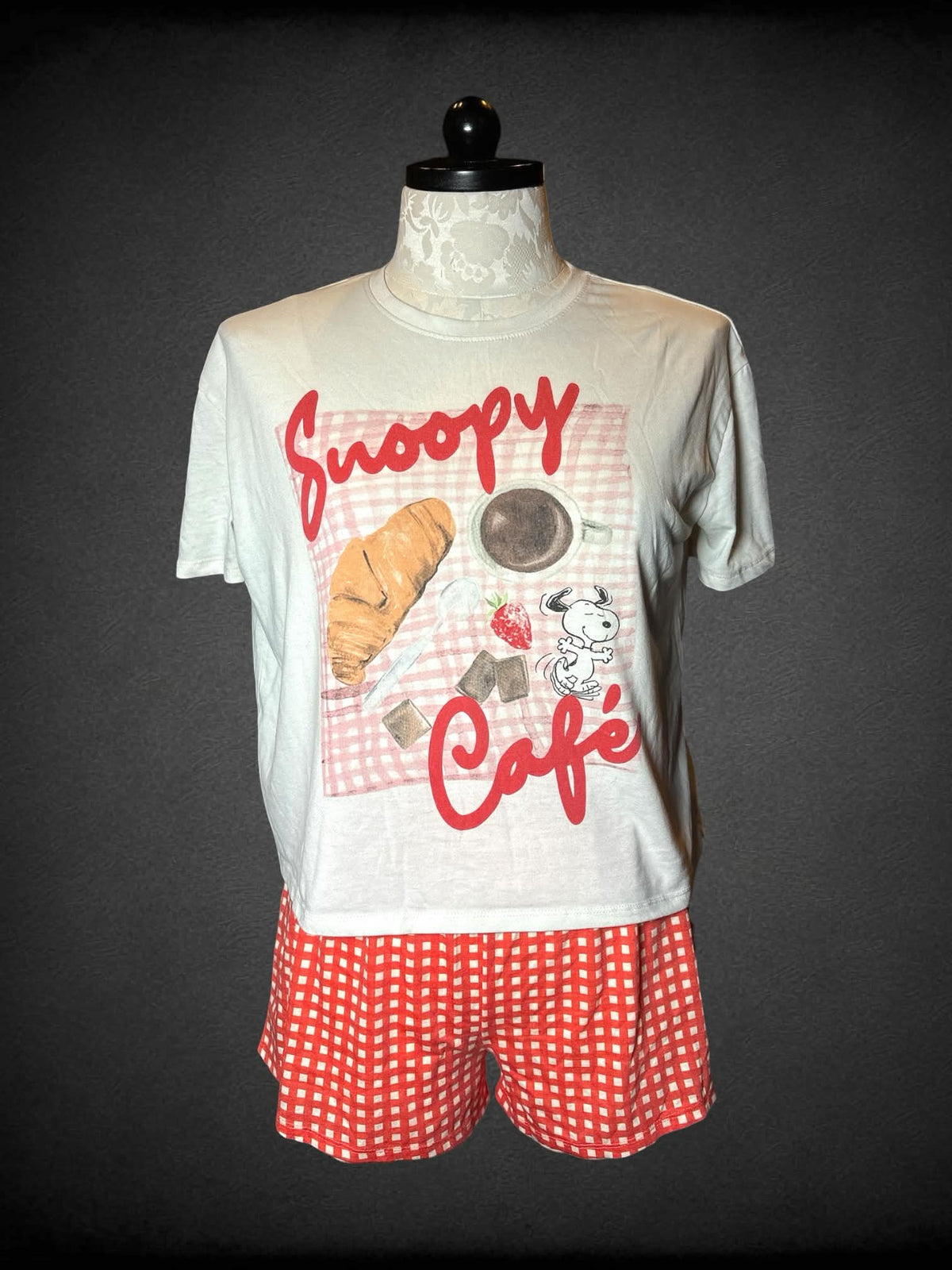 XL Peanuts two-piece set with white t shirt with “Snoopy Cafe” graphic, and orange soft grid shorts with stretch waist