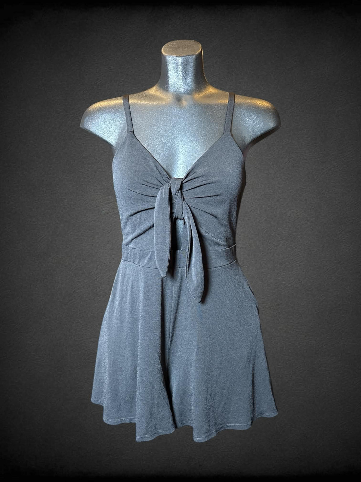 M Candie’s black jumpsuit with pockets, adjustable straps, and cinched design on front