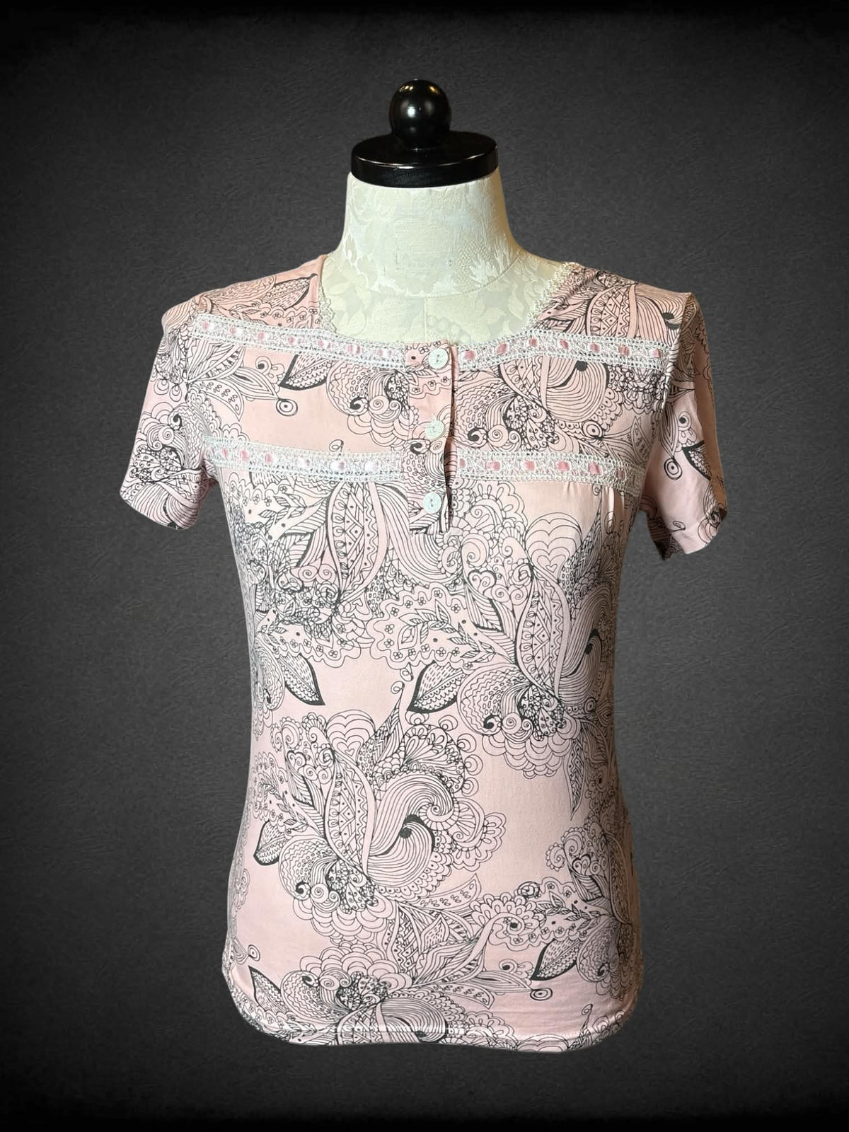 0X Joan Vass light pink soft t shirt with lace detailing and buttons on front, and black floral design