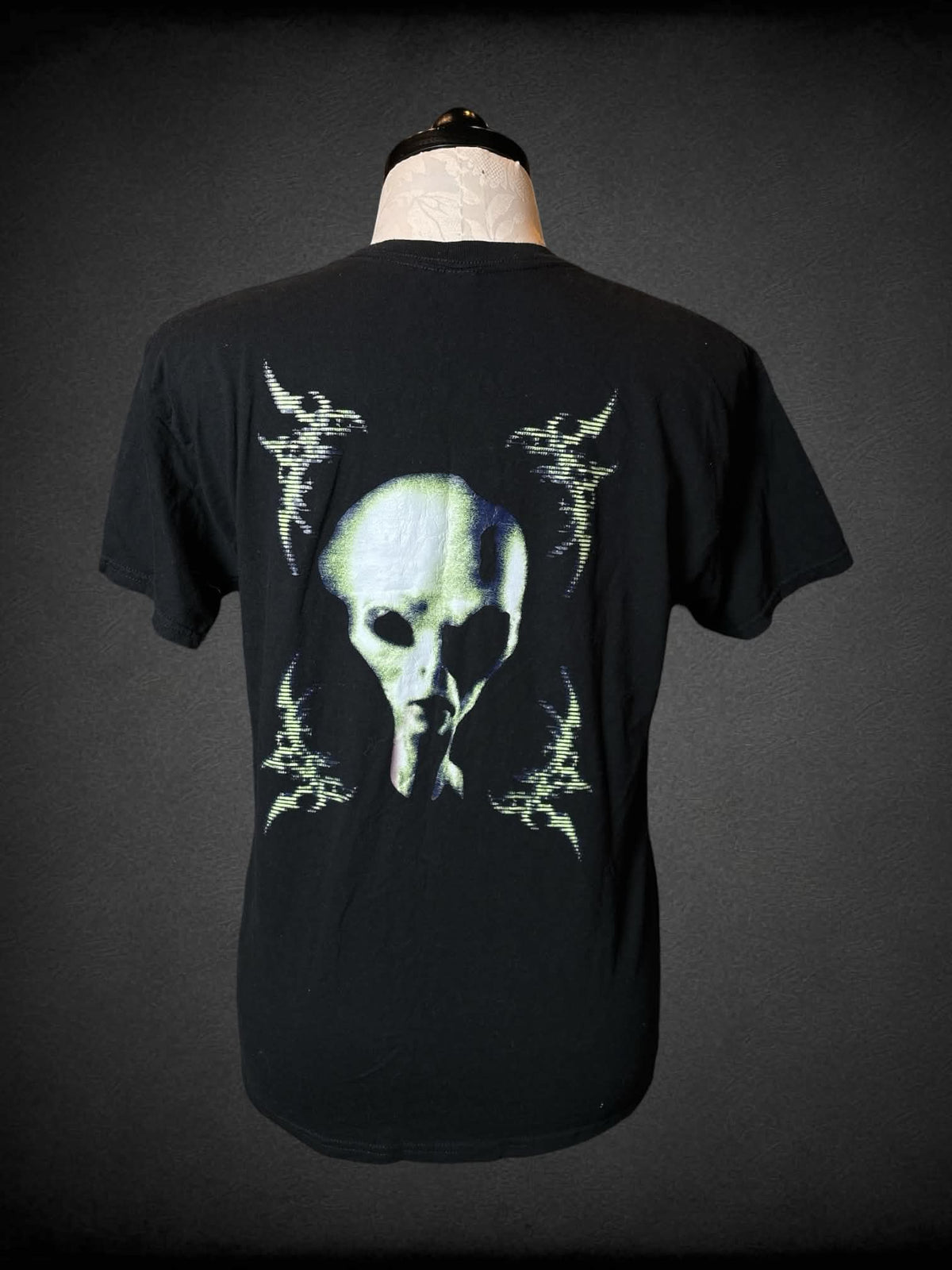 1X Gildan black t shirt with “Symposia” matrix writing on front, and alien graphic on back