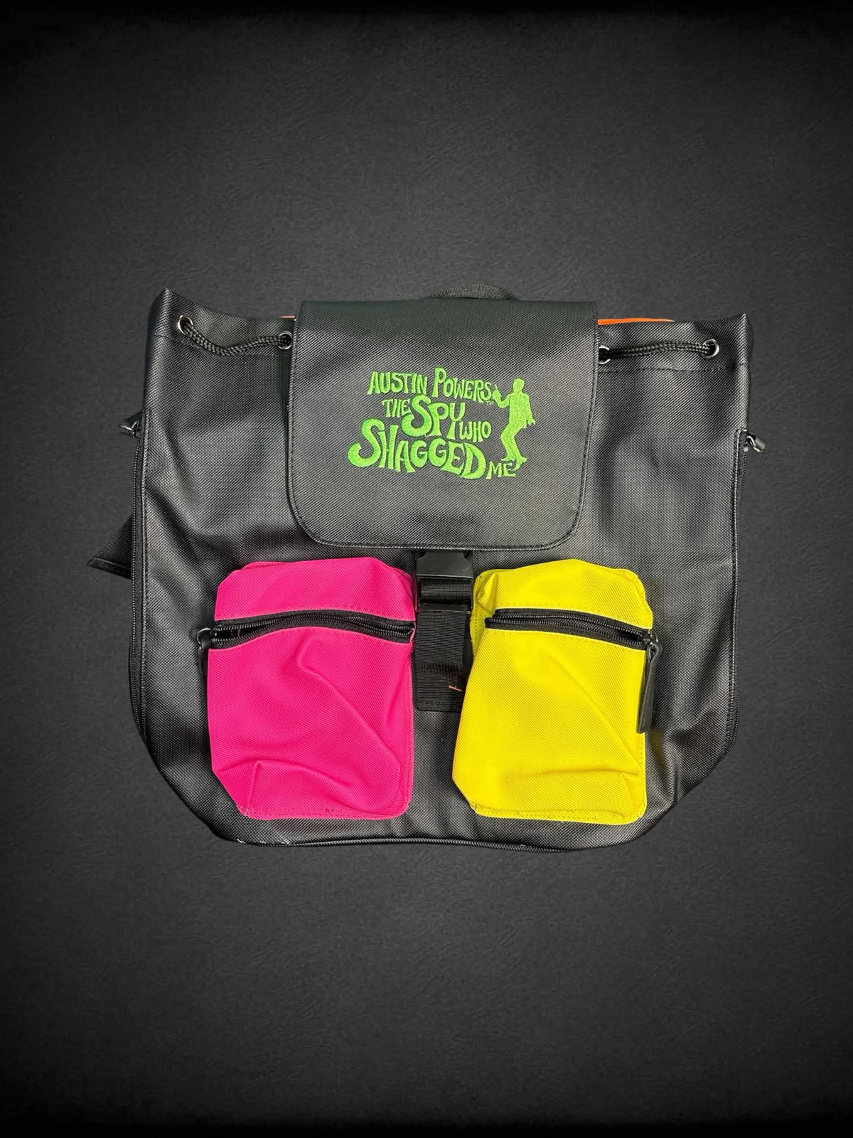 Austin Powers black color block backpack with embroidered “Austin Powers: The Spy Who Shagged Me” on front, and zipper pockets