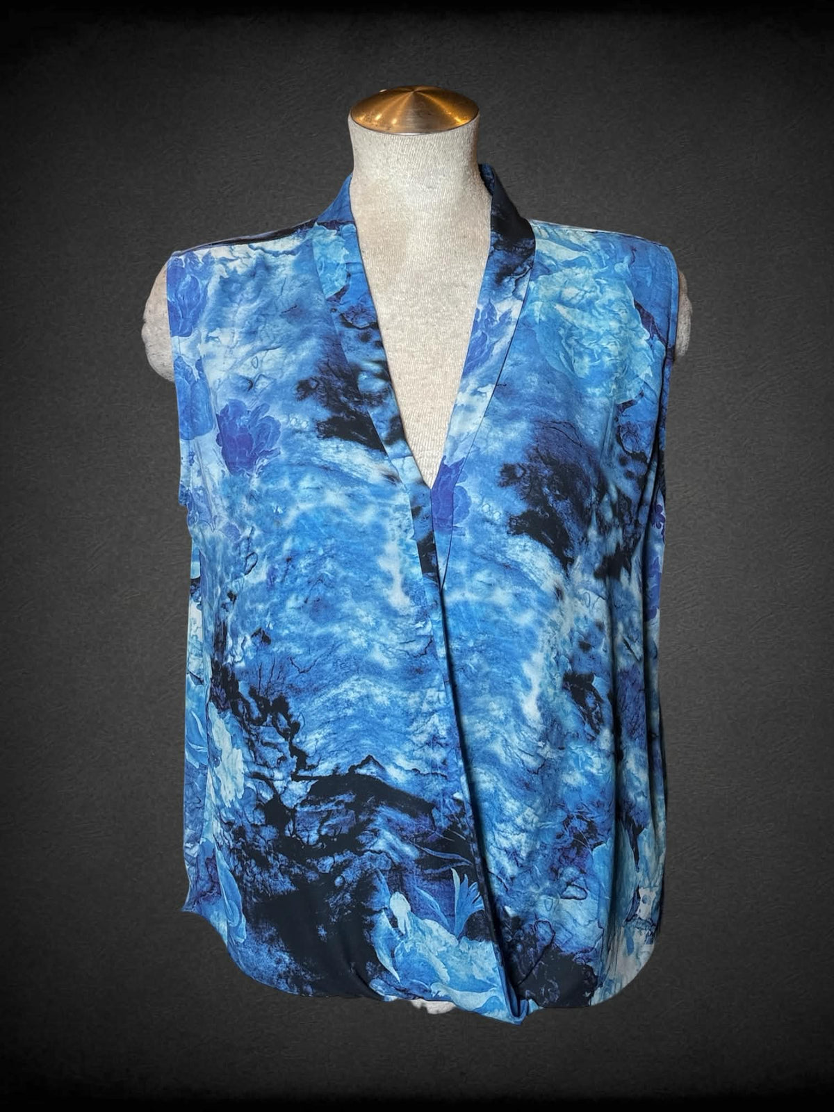 L Cliché Couture blue flowy blouse with wrap-around design on front, and abstract flower pattern