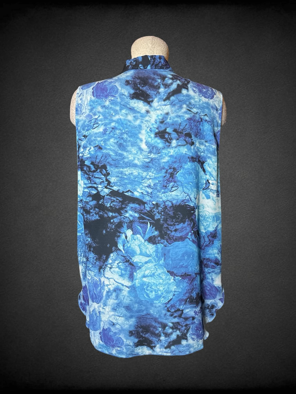 L Cliché Couture blue flowy blouse with wrap-around design on front, and abstract flower pattern