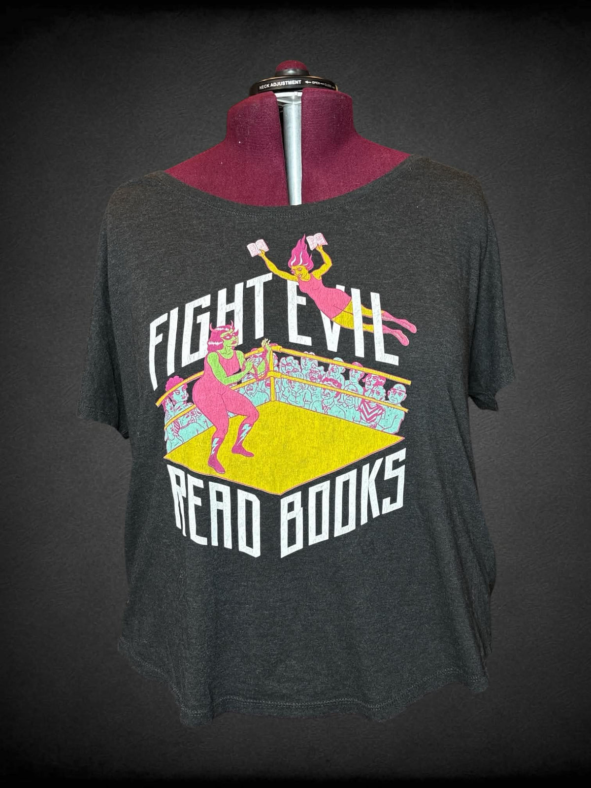 2X Out of Print charcoal grey t shirt with “Fight Evil, Read Books” writing and wrestling graphic on front