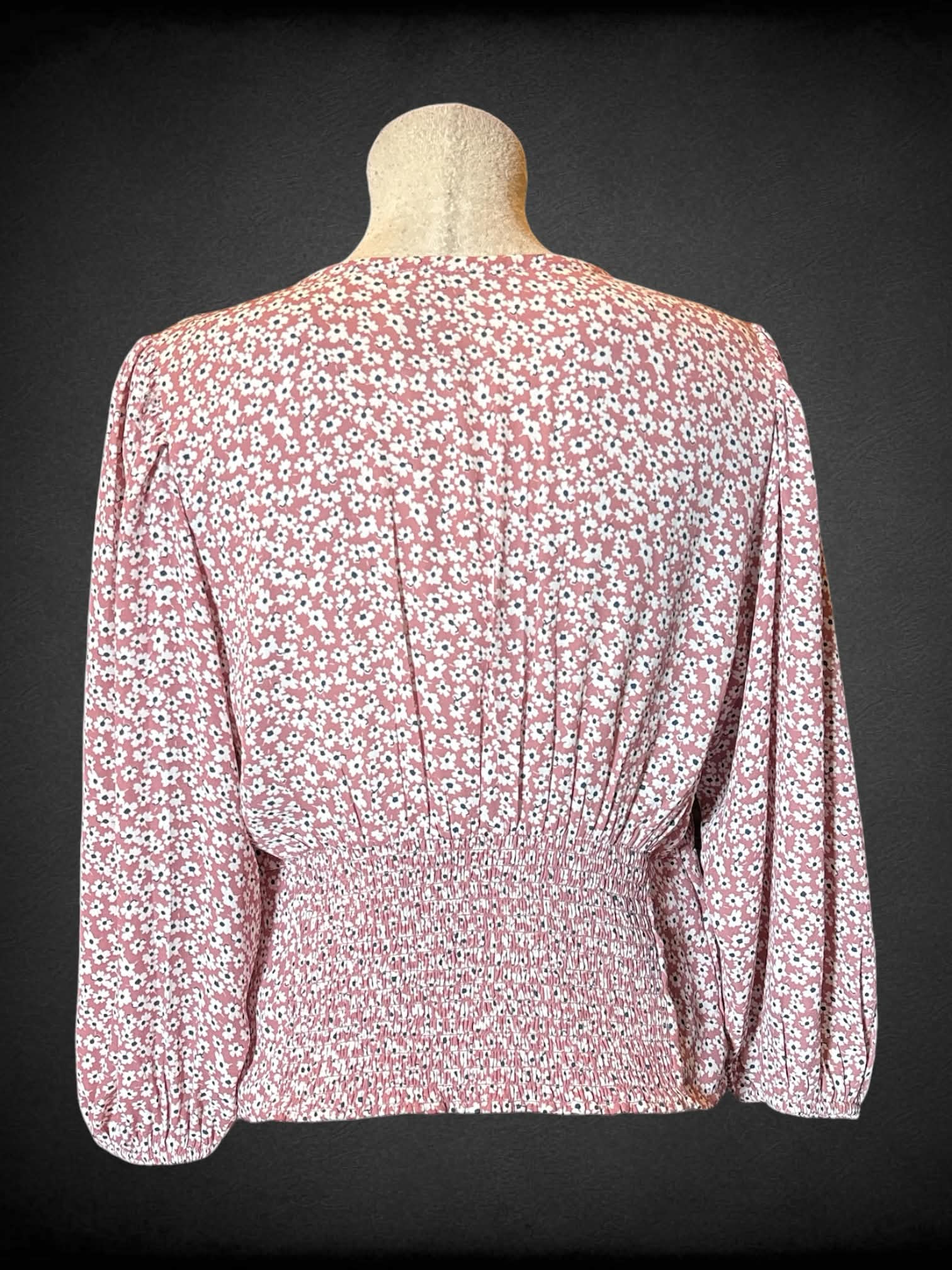 L Abercrombie & Fitch pink long sleeved faux wrap top with clasp in middle, floral design, shirred back, and balloon sleeves