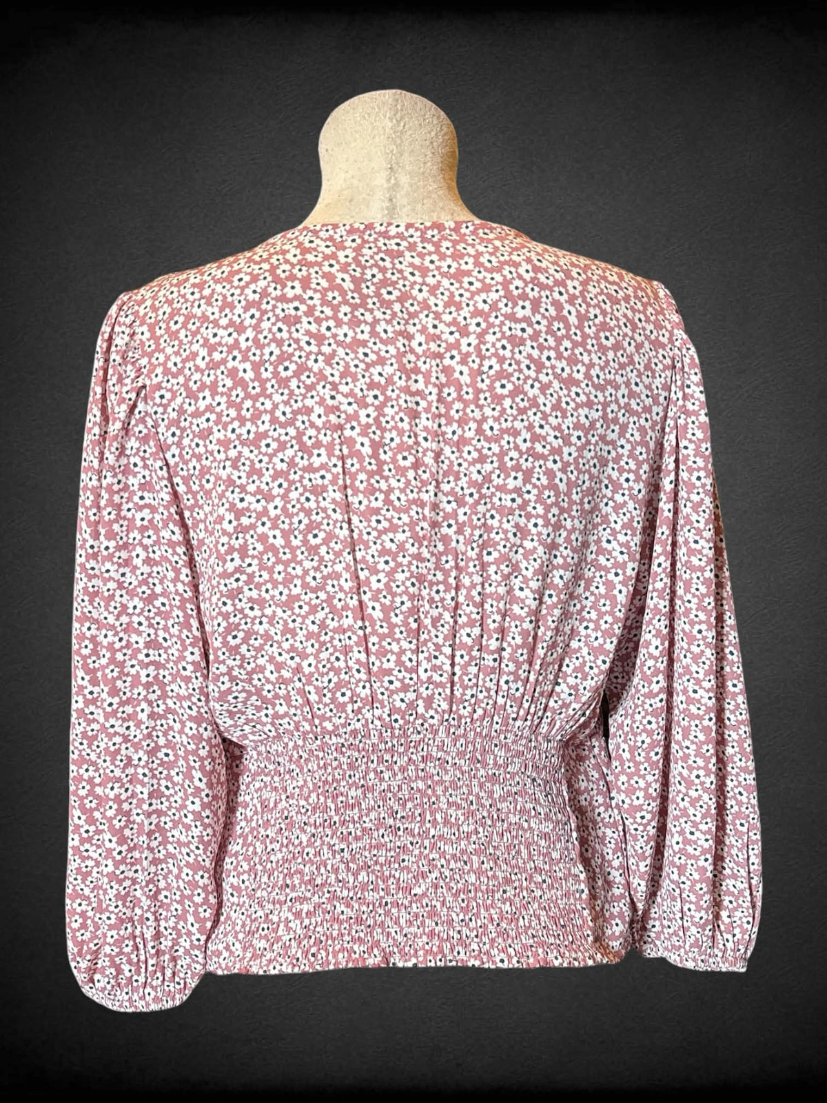 L Abercrombie & Fitch pink long sleeved faux wrap top with clasp in middle, floral design, shirred back, and balloon sleeves