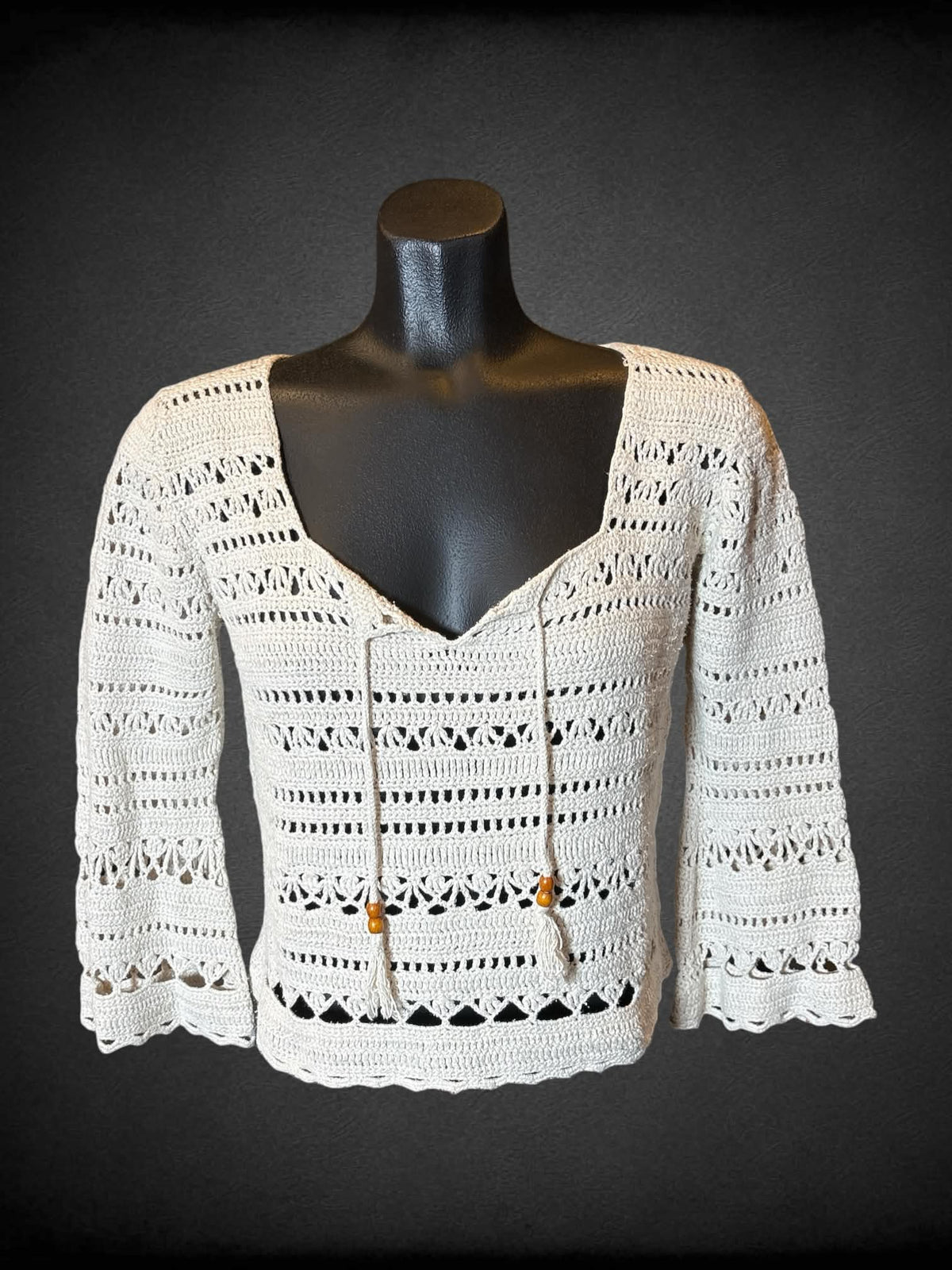 M Tommy Hilfiger hand knit off white knit top with tie on front, and red beads on bottom hem and sleeves