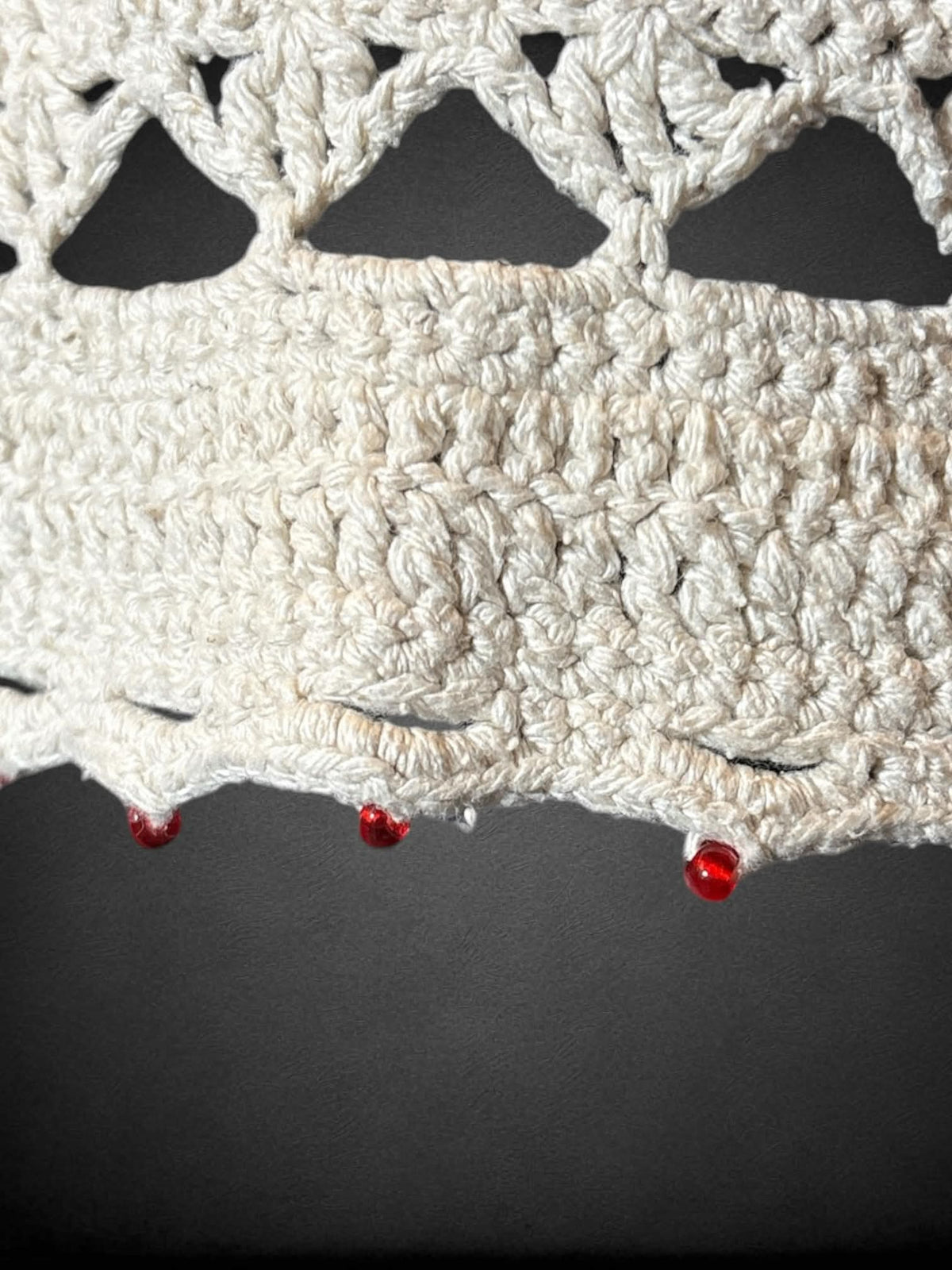 M Tommy Hilfiger hand knit off white knit top with tie on front, and red beads on bottom hem and sleeves