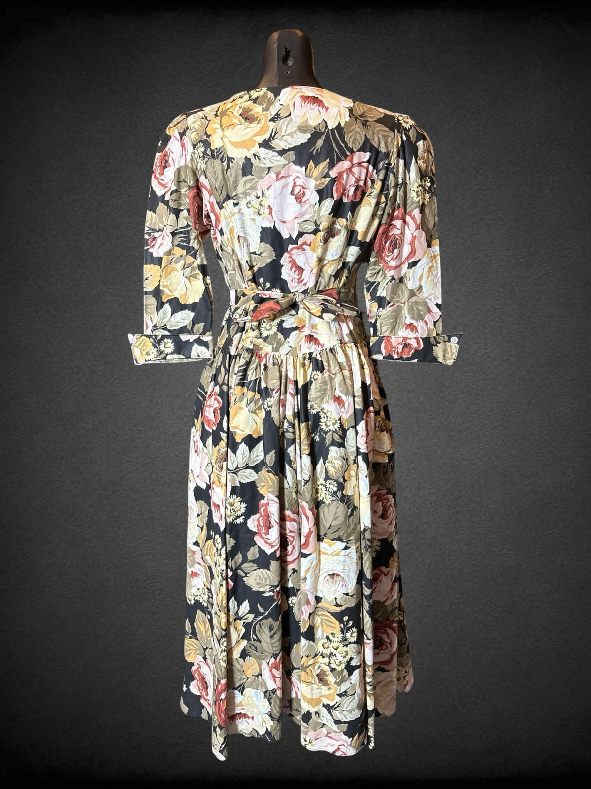 M Expo vintage black short sleeve floral dress with half buttons on front, tie on back, flared hips, and pockets
