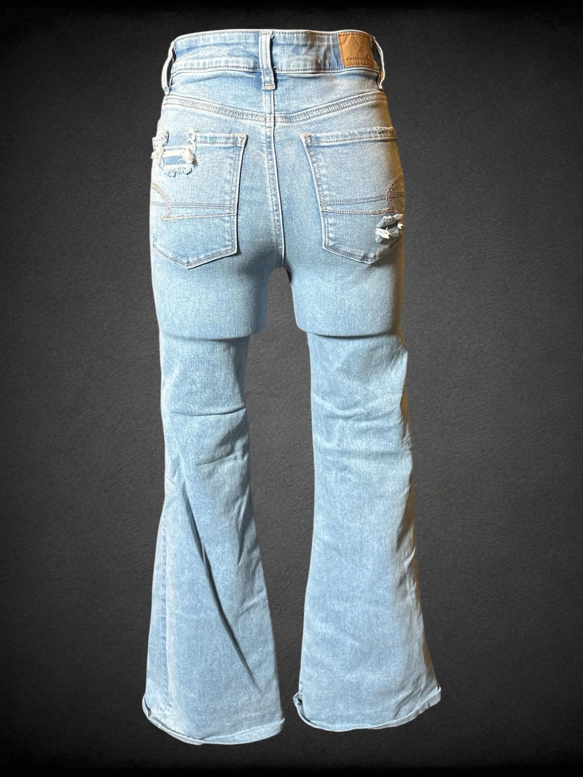 S American Eagle light blue jeans with distressing, pockets, and flared legs