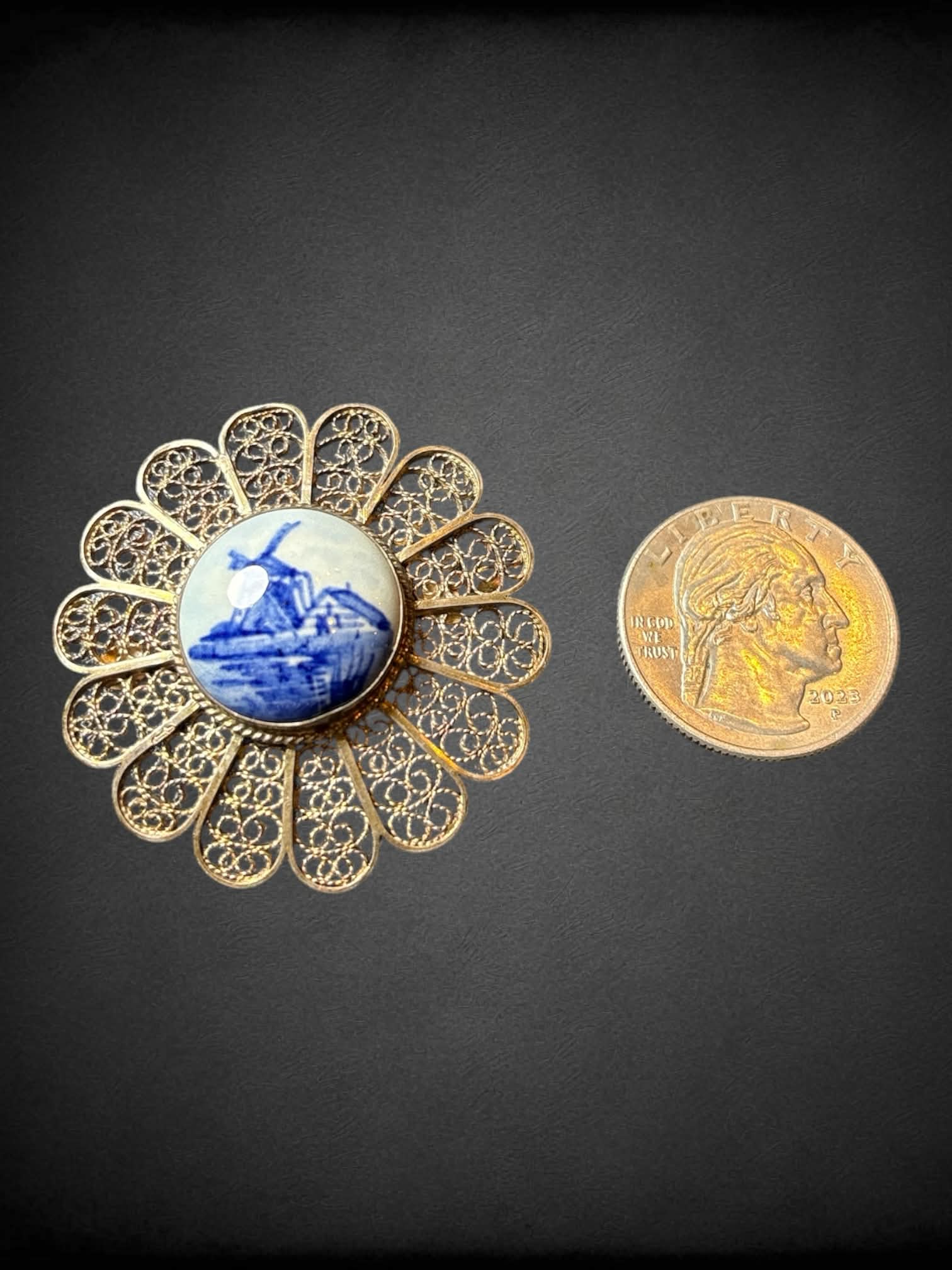 Vintage silver floral brooch with intricate open work wire, and porcelain center