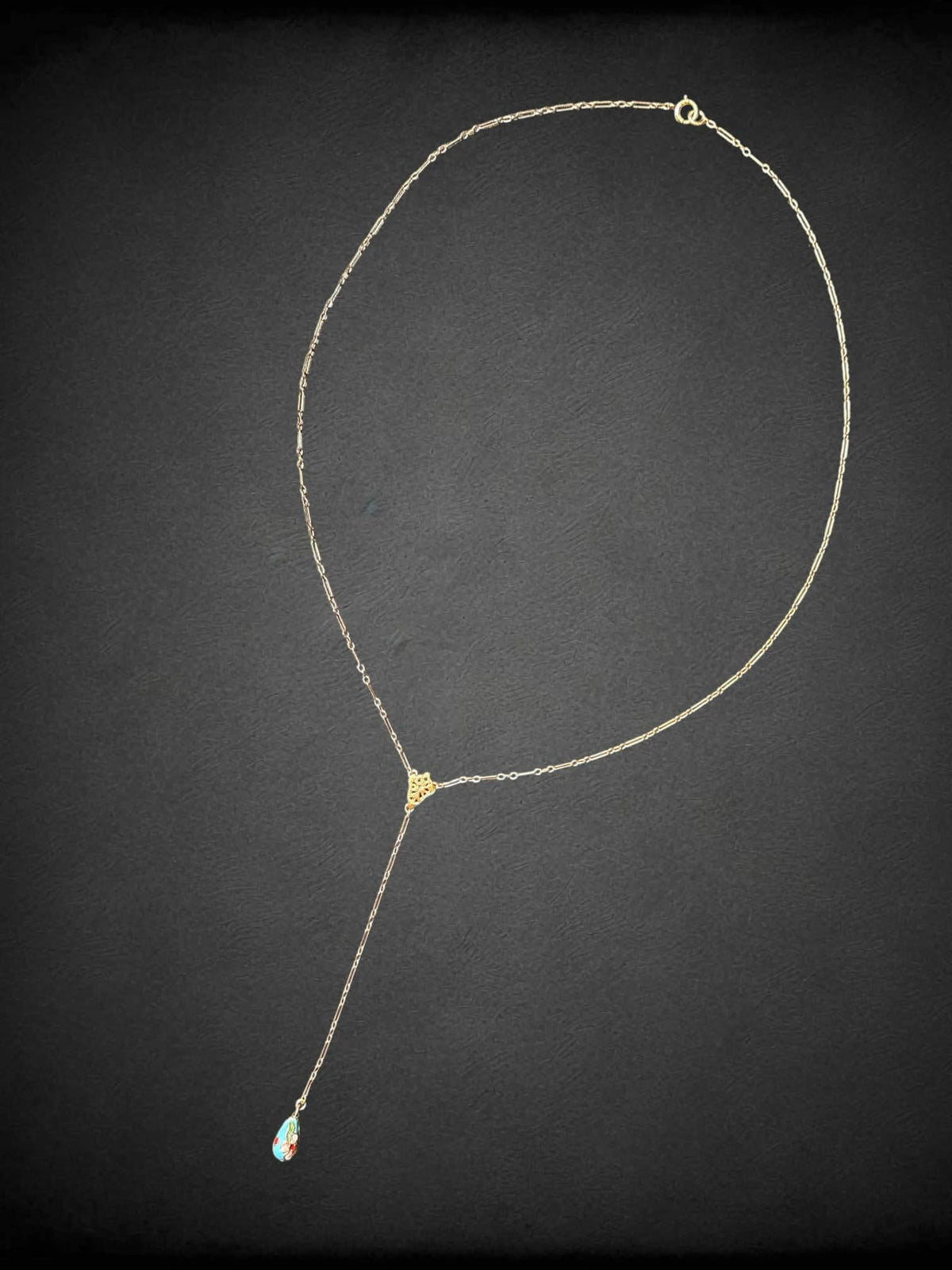 Gold tone necklace with dangling blue beaded pendant