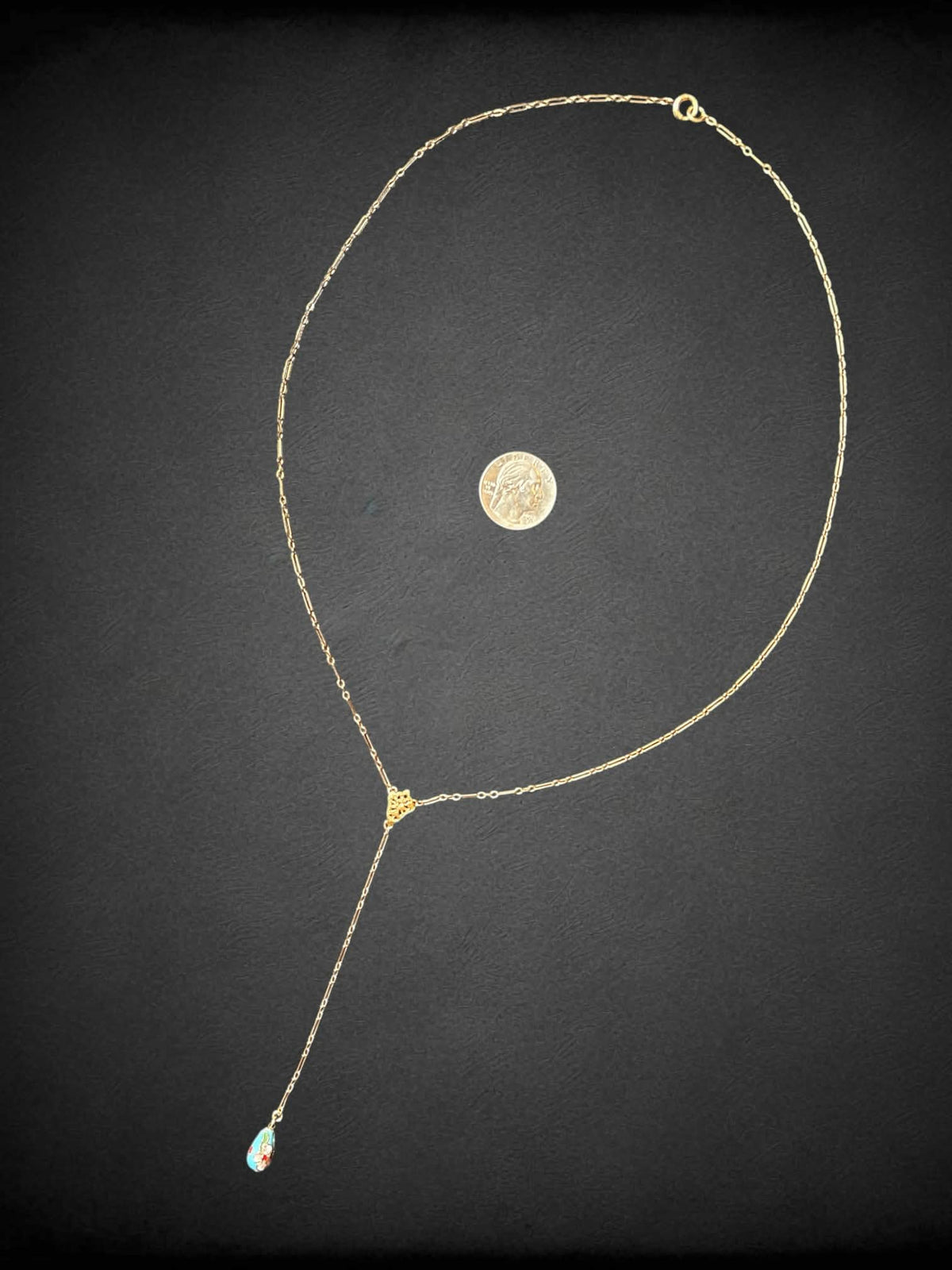 Gold tone necklace with dangling blue beaded pendant