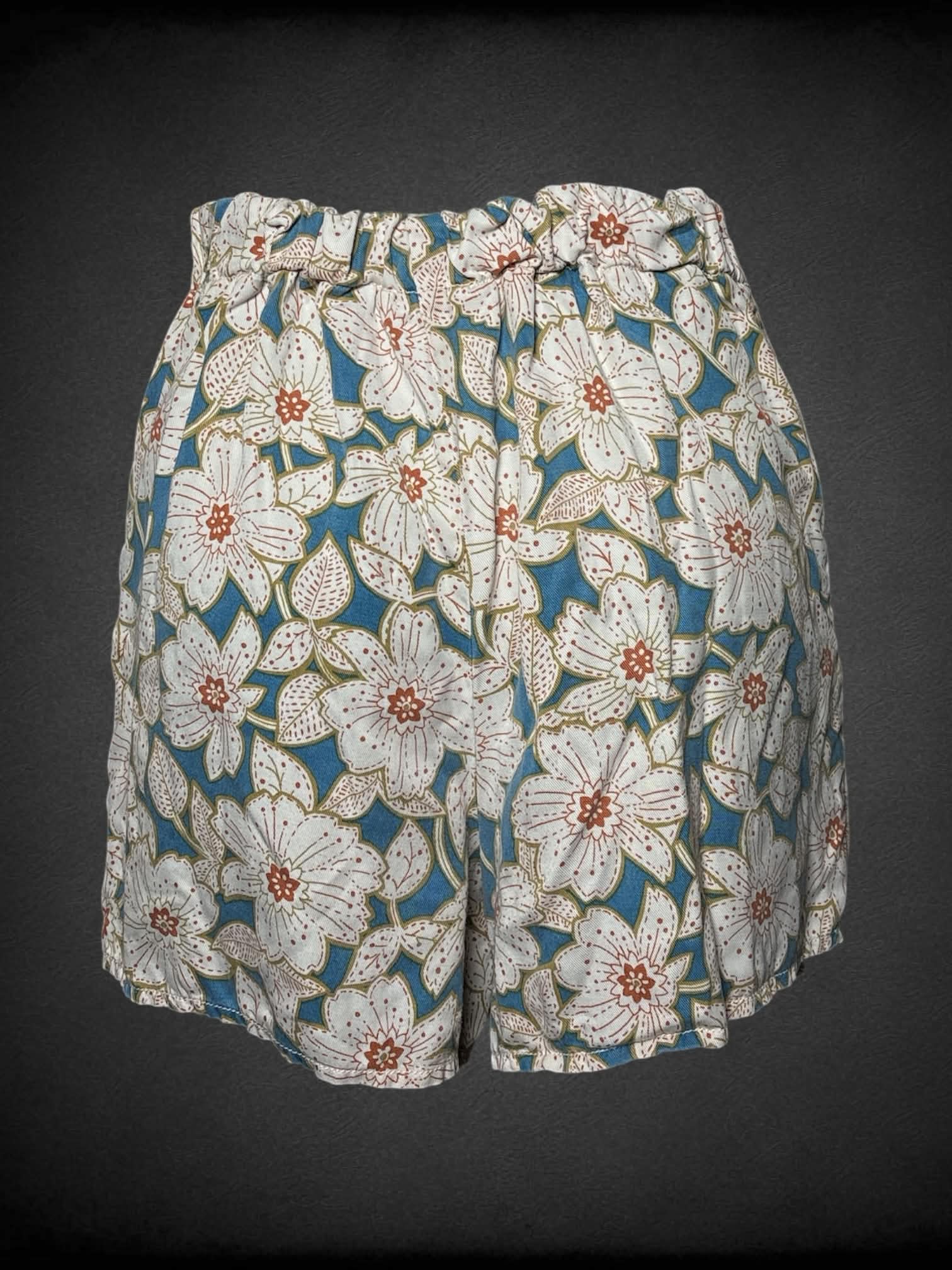 S Anthropologie blue wrap-around shorts with floral design, and zipper on side